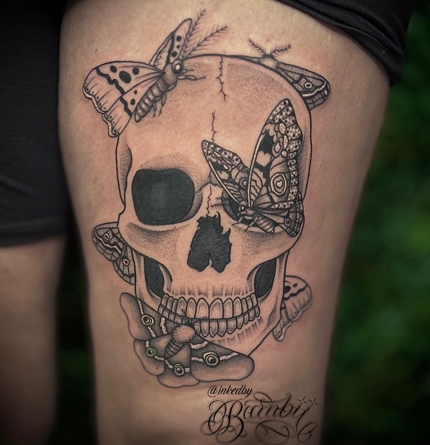 Skull with butterflies dotwork tattoo on the thigh by Ember