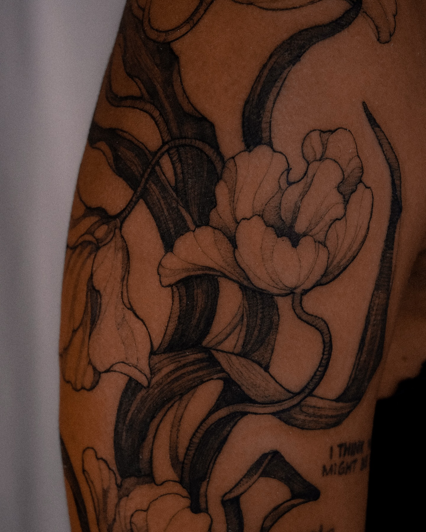 Floral arrangement black and grey tattoo on the forearm by Alena Zozulenko