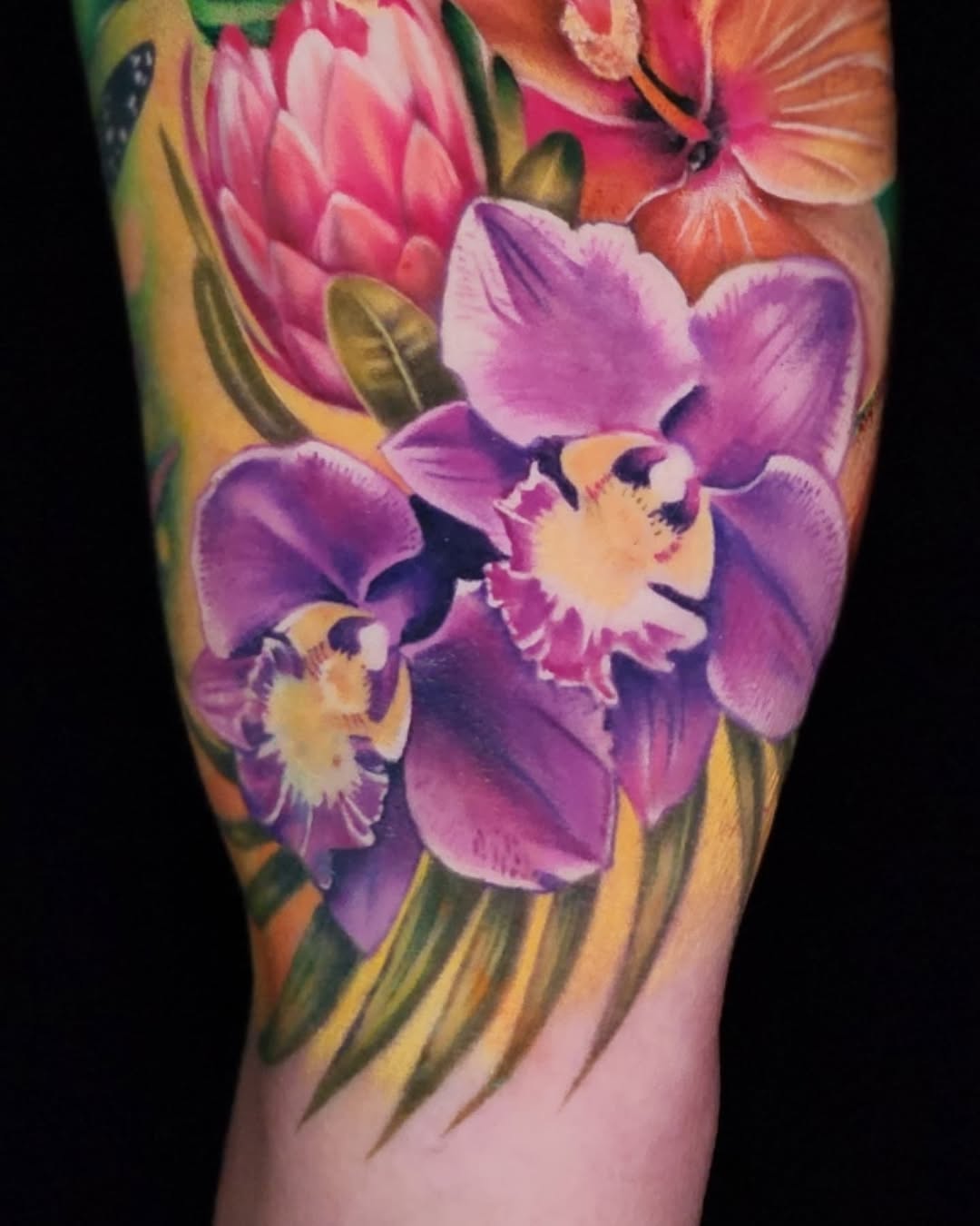 Tropical flowers watercolor tattoo on the forearm by Su Kang