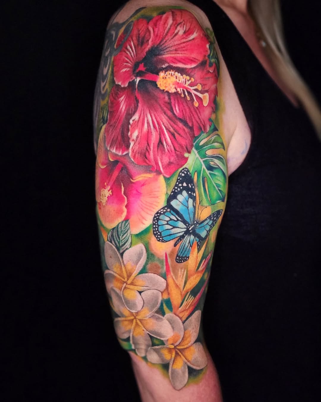 Hibiscus flowers and butterfly watercolor tattoo on the forearm by Su Kang