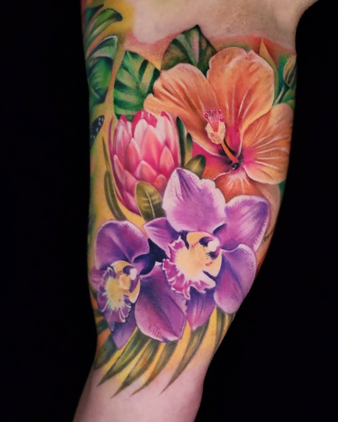 Tropical flowers watercolor tattoo on the forearm by Su Kang