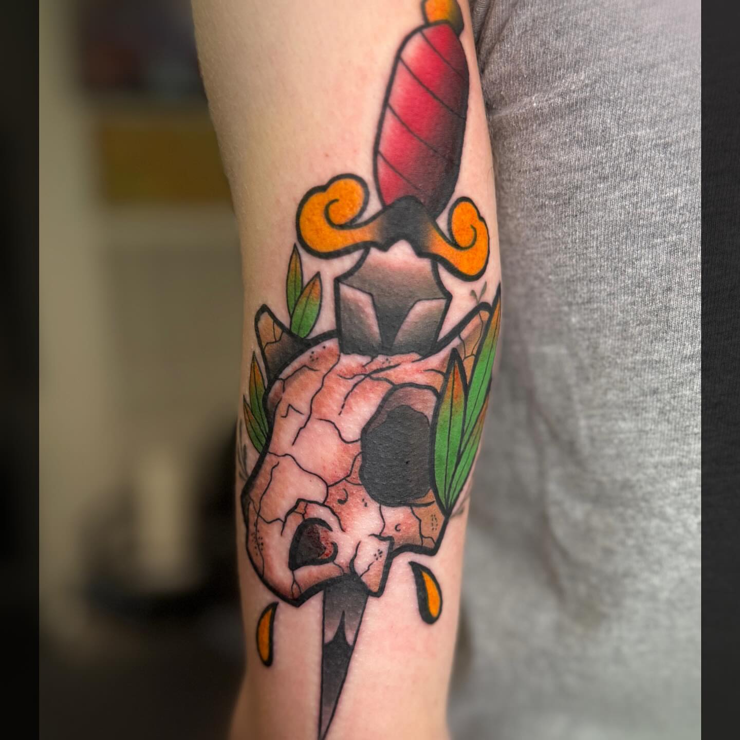 Skull and dagger American traditional tattoo on the forearm by Romans