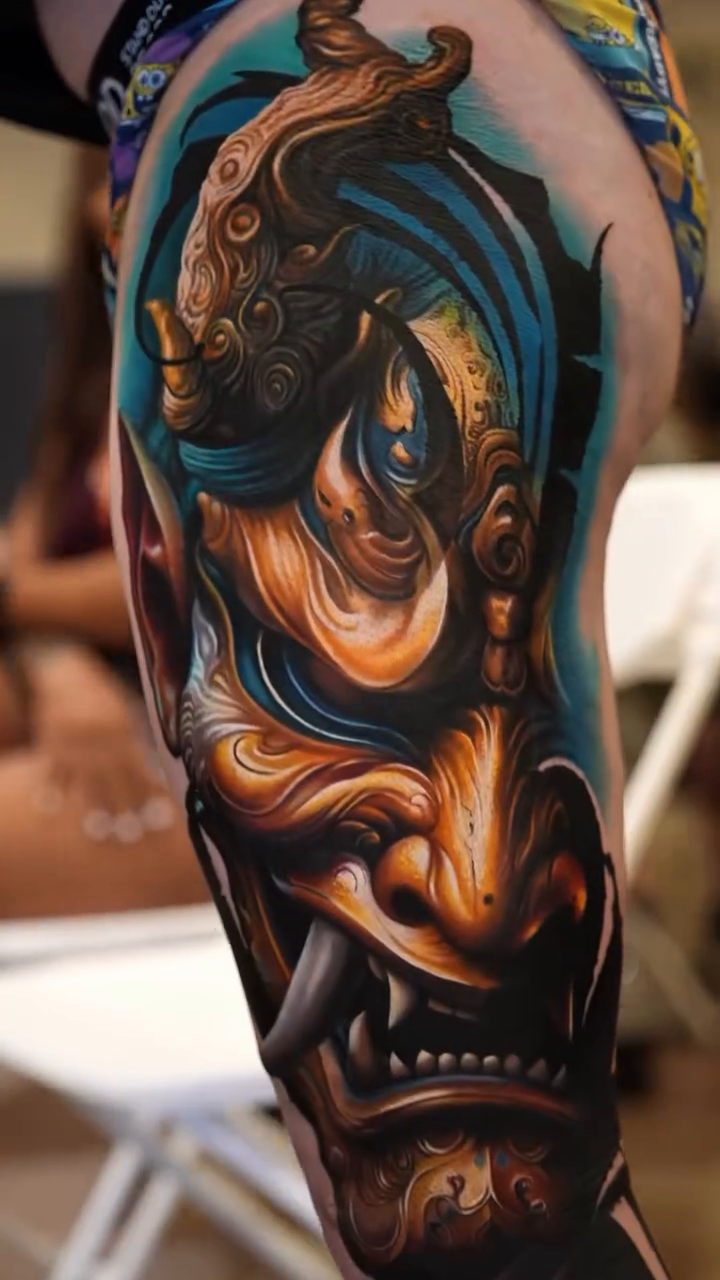 Hannya mask and serene face Japanese tattoo on the upper arm by Guillermo Columbie, Houston, Texas