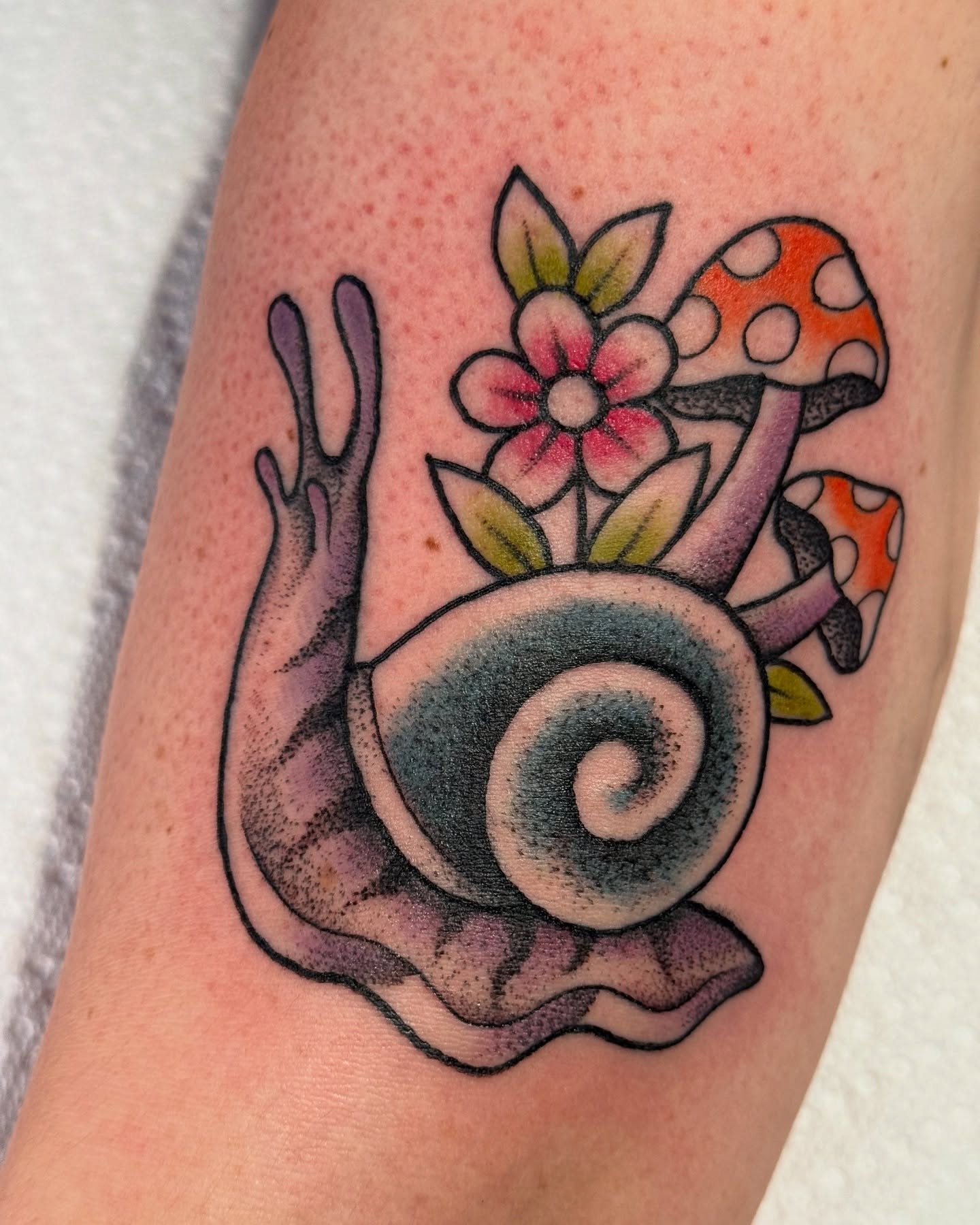 Snail and mushrooms American traditional tattoo on the forearm by jenna clark🎨