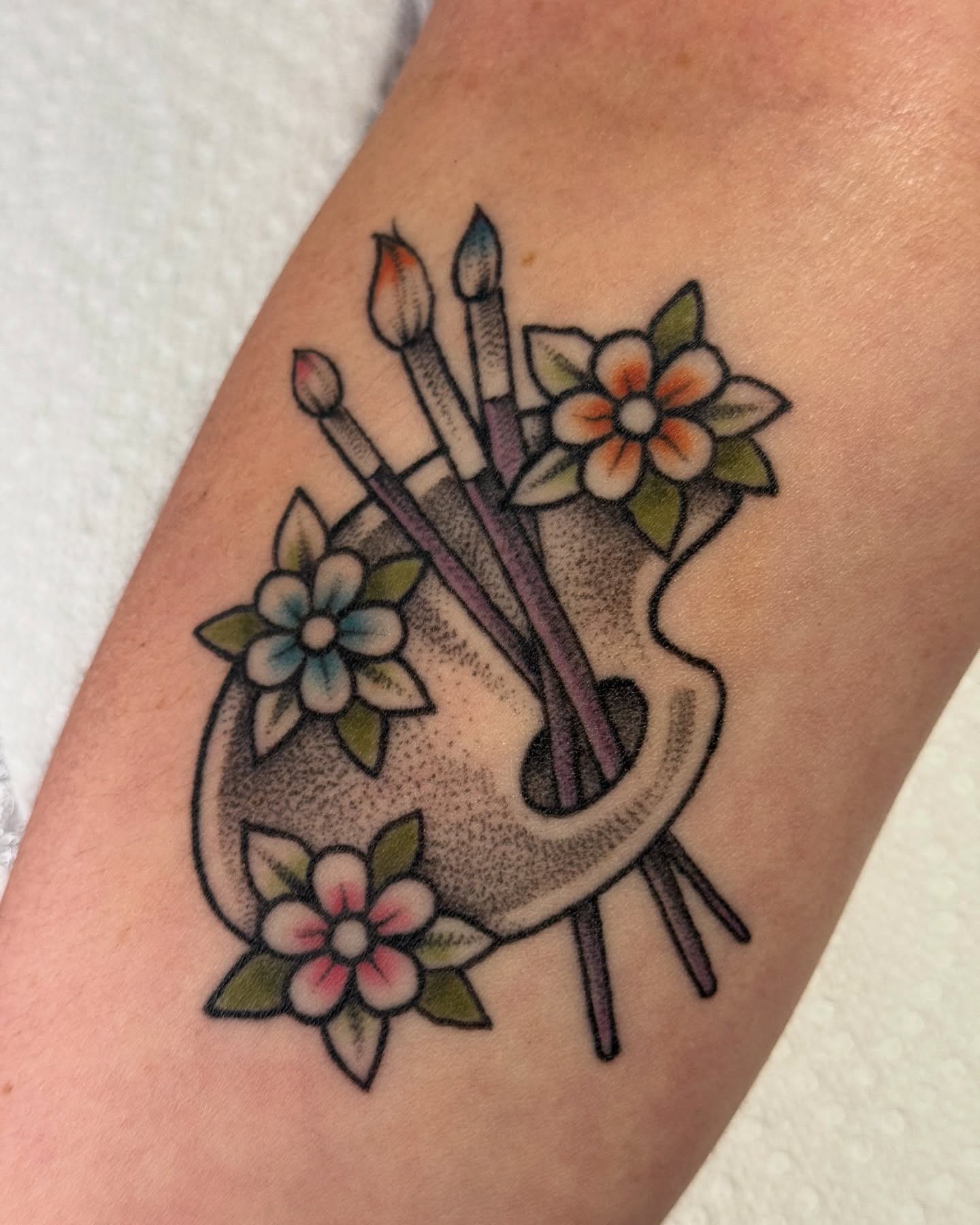 Flower vase with paintbrushes American traditional tattoo on the forearm by jenna clark🎨