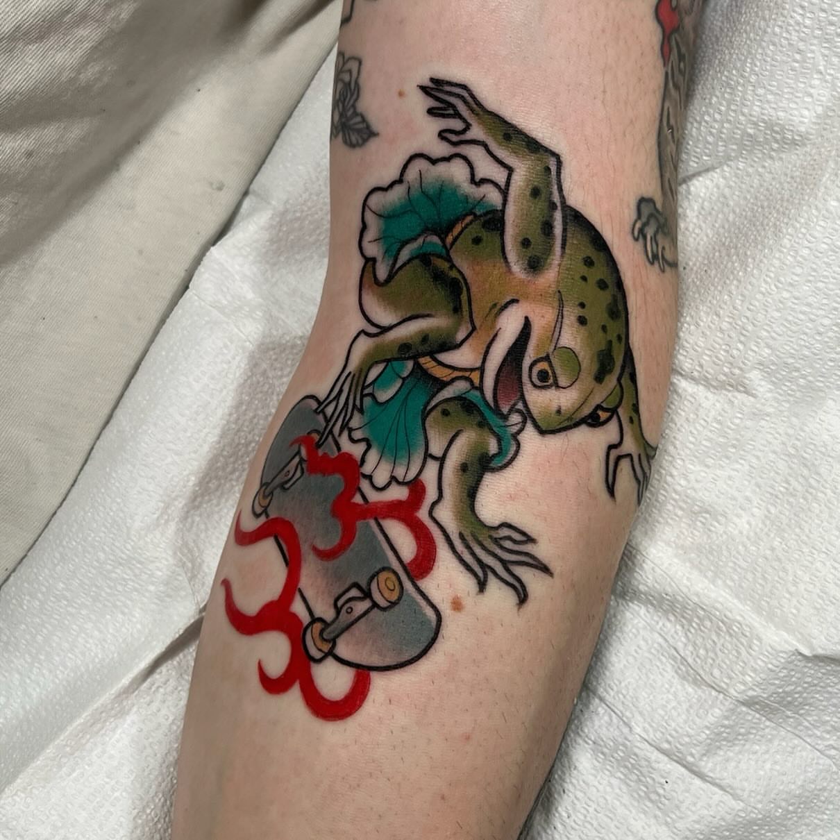 Frog on skateboard American traditional tattoo on the forearm by Kyle Olson, Salt Lake City, Utah