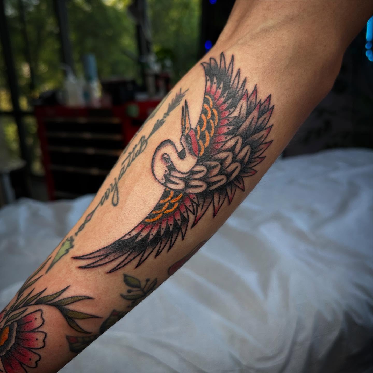 Flamingo and flowers American traditional tattoo on the forearm by Jess Ritchie, Austin, Texas