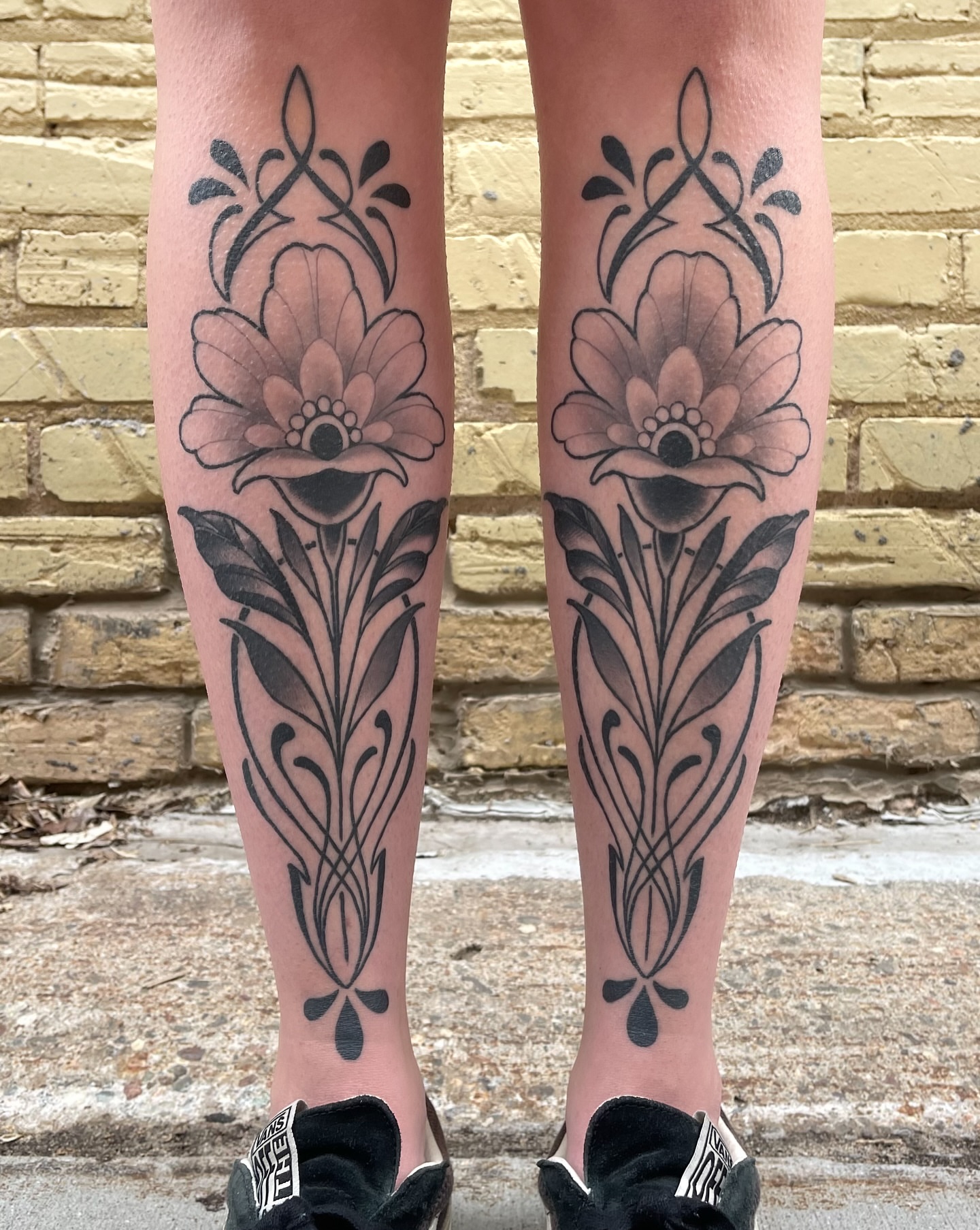 Flower black and grey tattoo on the calf by Corra Carmine