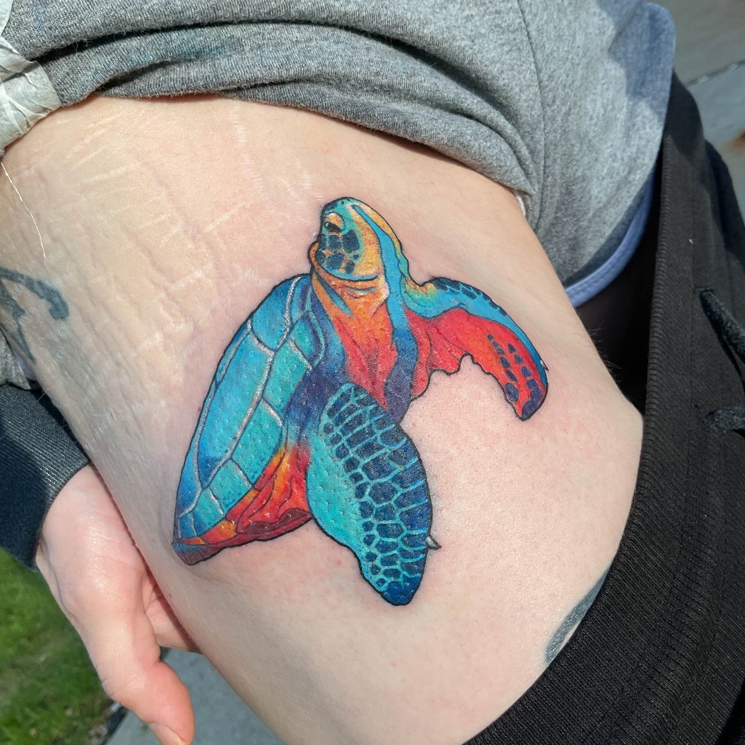 Sea turtle watercolor tattoo on the thigh by Iram Withencroft