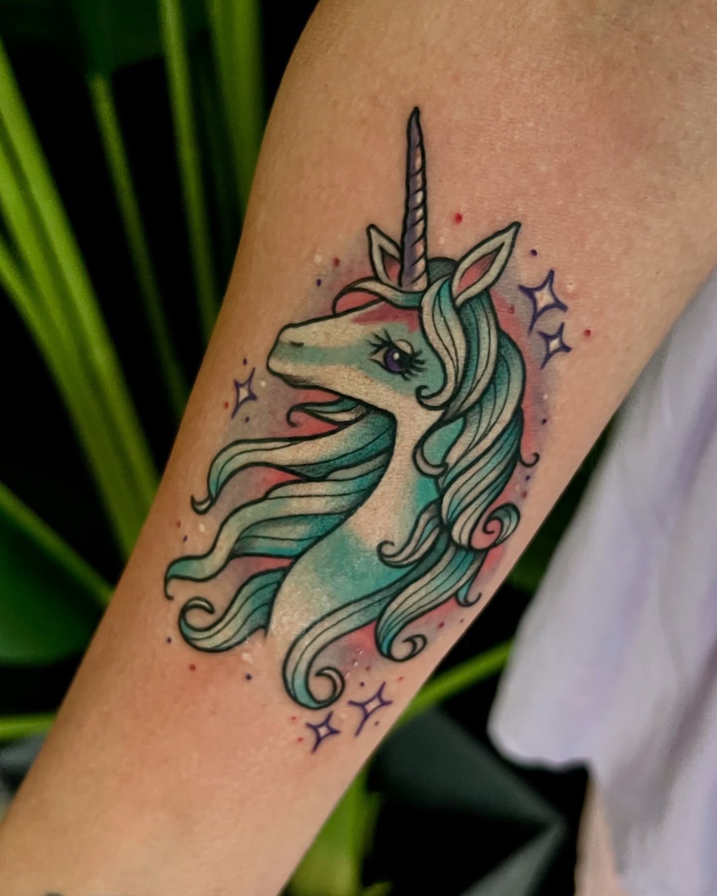 Unicorn watercolor tattoo on the forearm by Jordyn Tinney