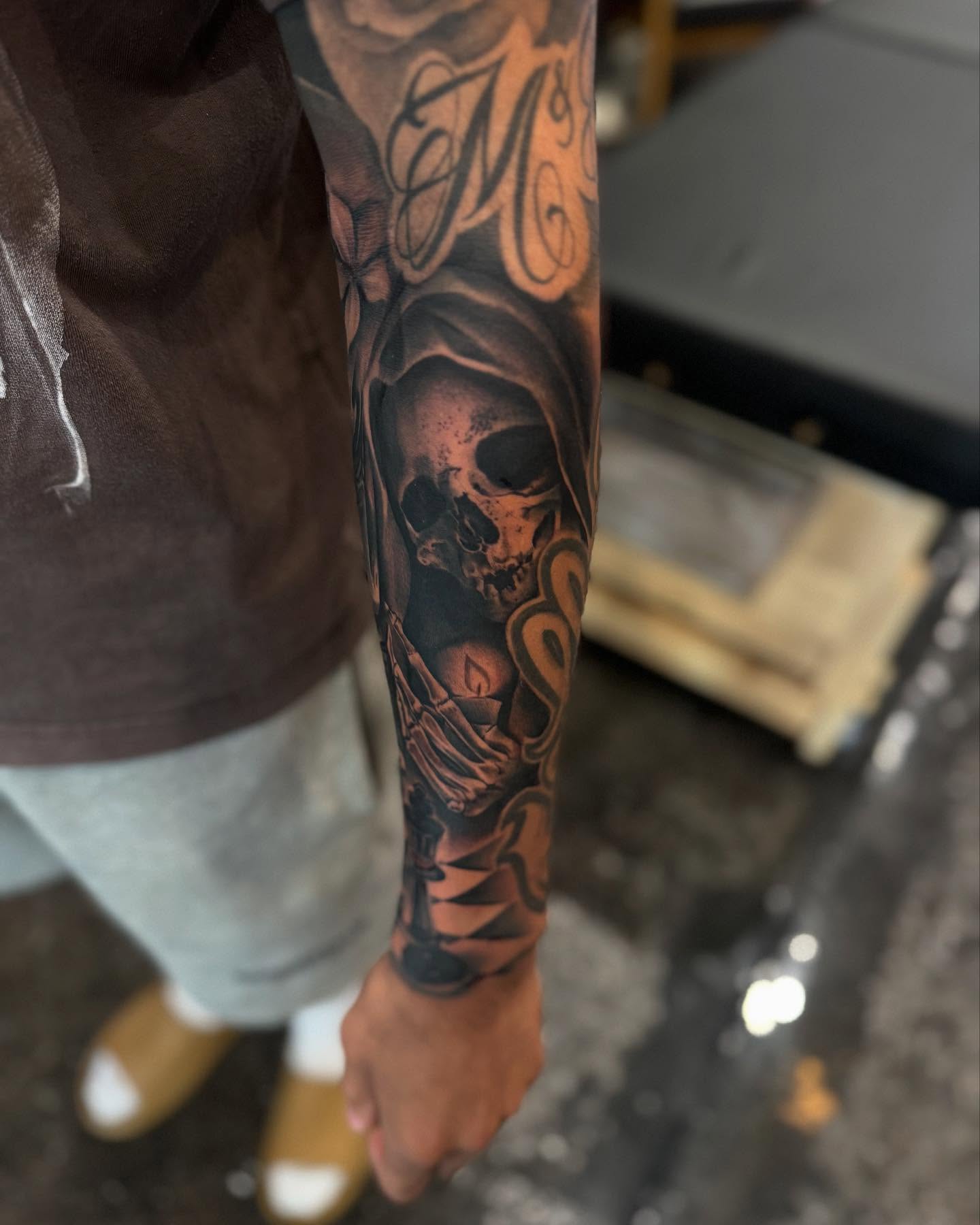 Skull and candle dark realism tattoo on the forearm by Bernie calderon, Fresno, California
