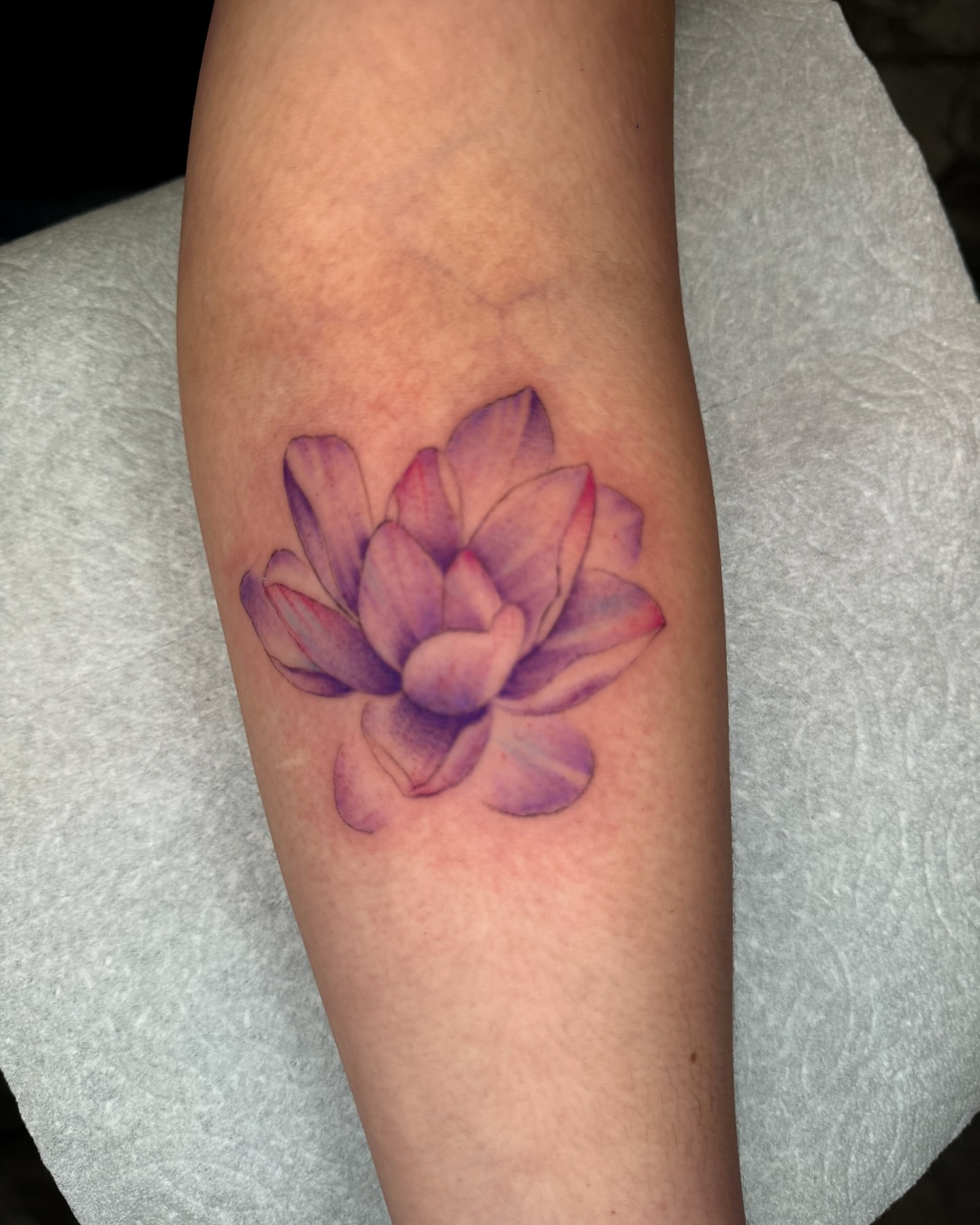 Lotus flower watercolor tattoo on the forearm by Gabah🌹