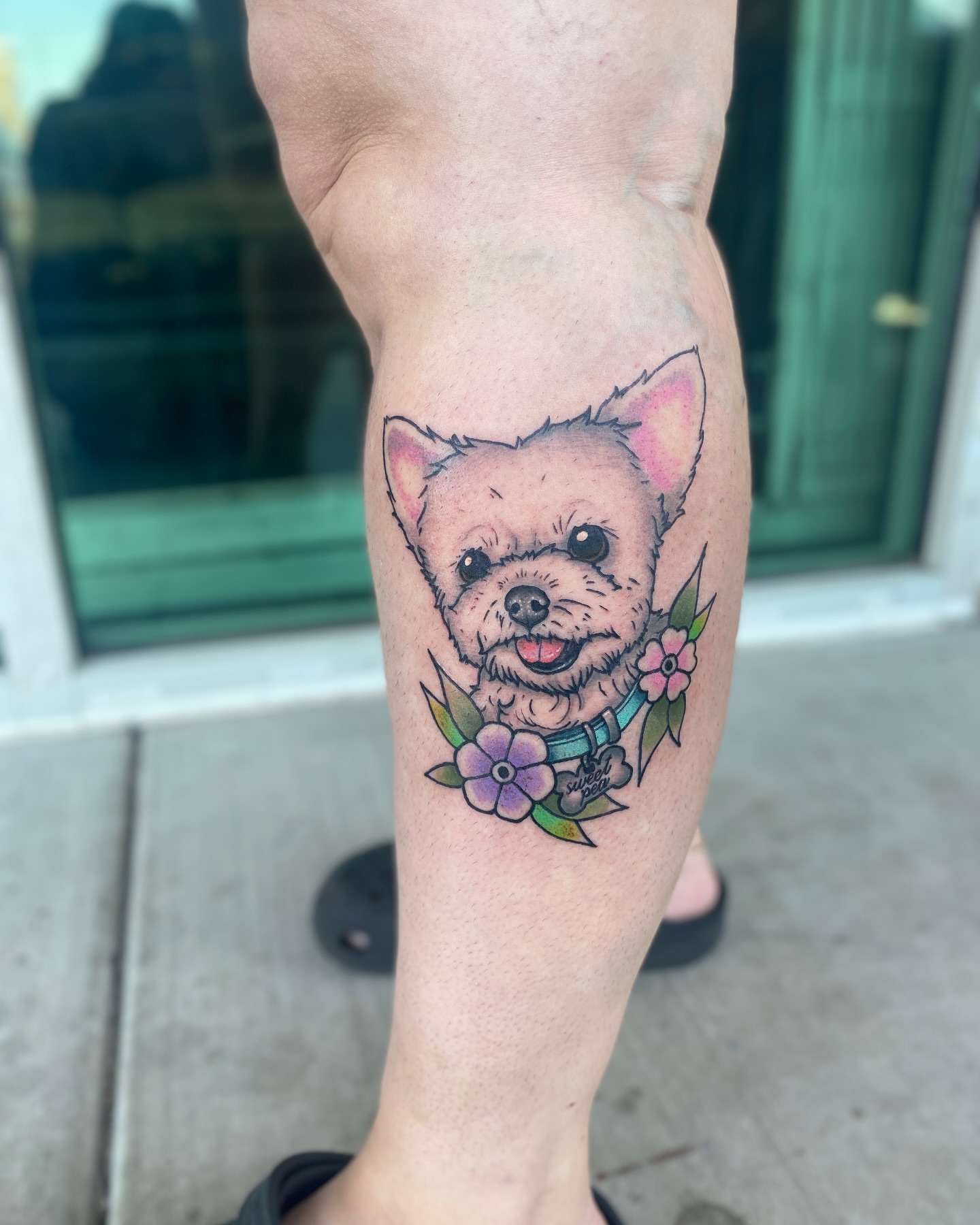 Dog with flowers realism tattoo on the forearm by Elliot Jaye Valentine