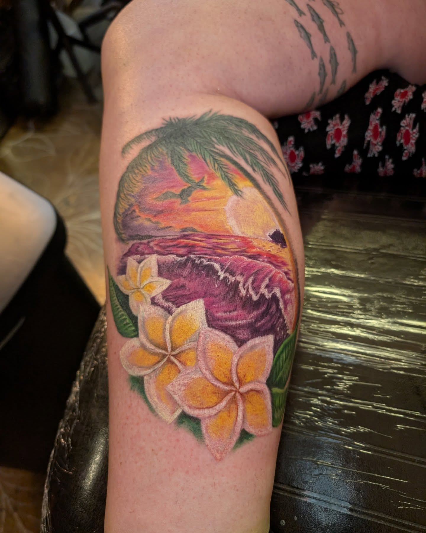 Sunset and tropical flowers new school tattoo on the forearm by Cat