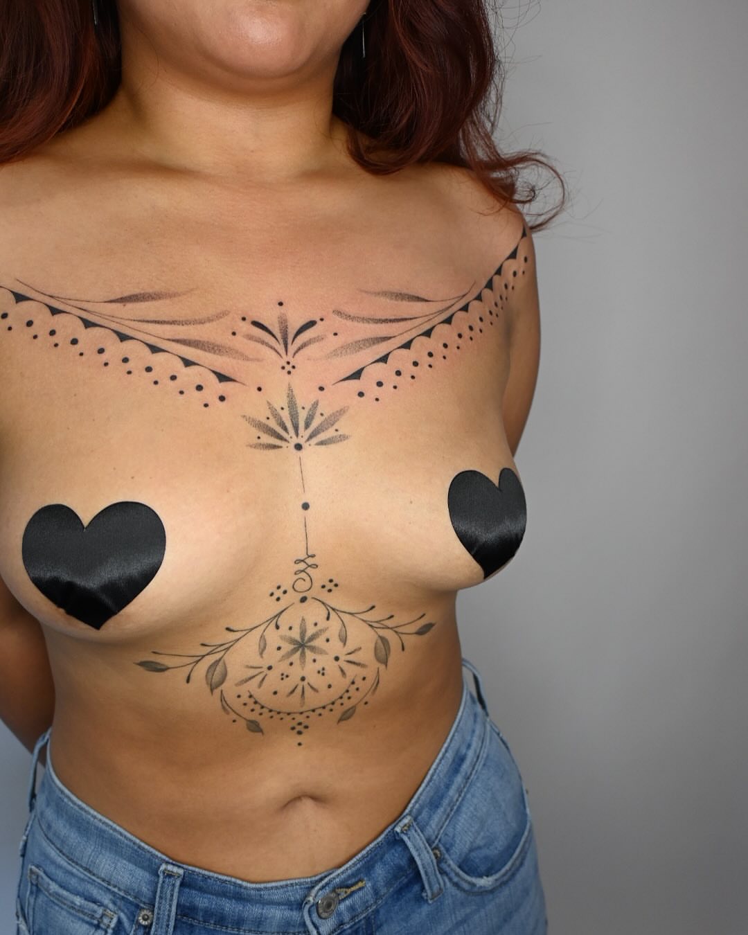 Heart and floral dotwork tattoo on the chest by Simba Nguyen