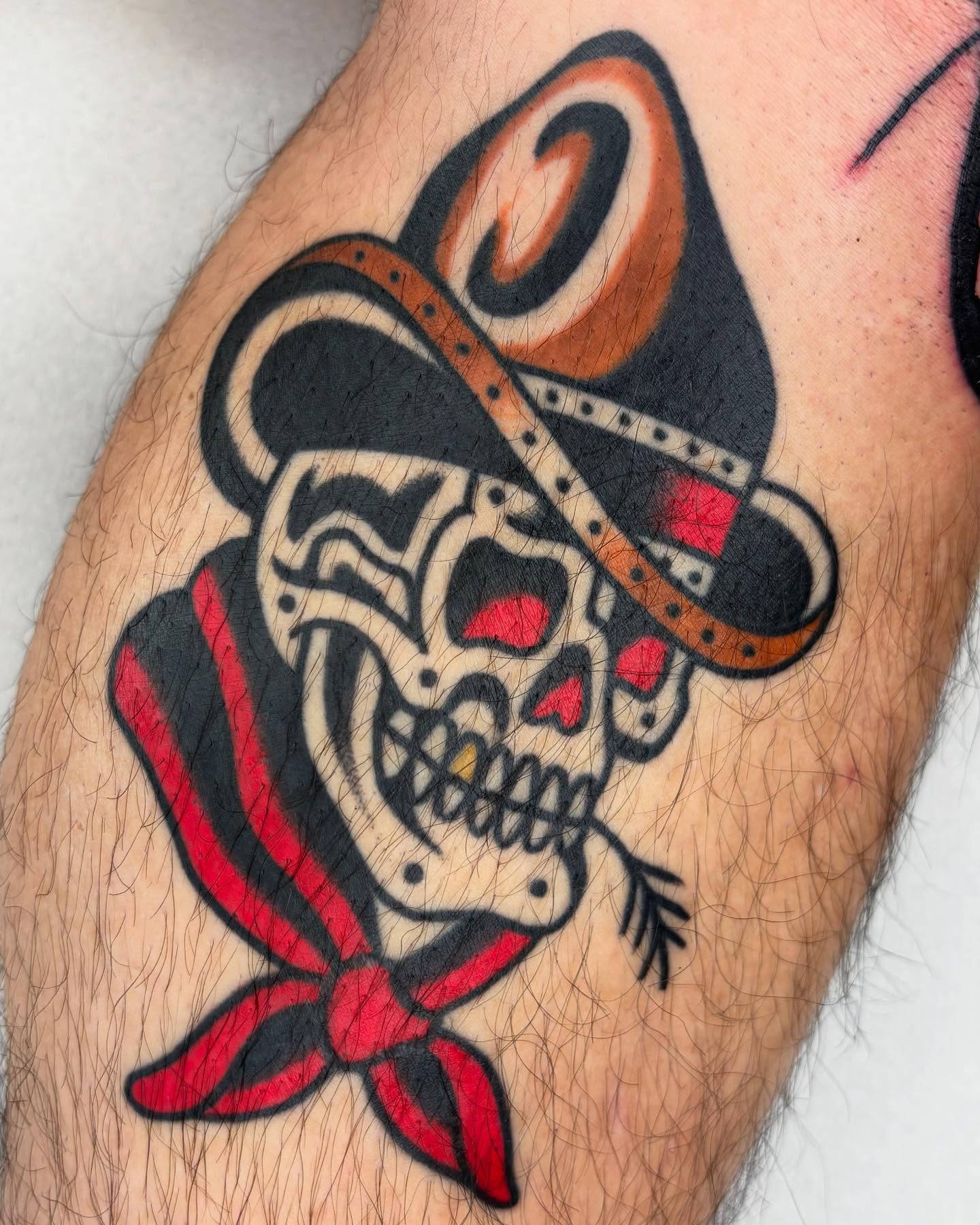 Skull wearing hat American traditional tattoo on the forearm by Arturo Ledesma