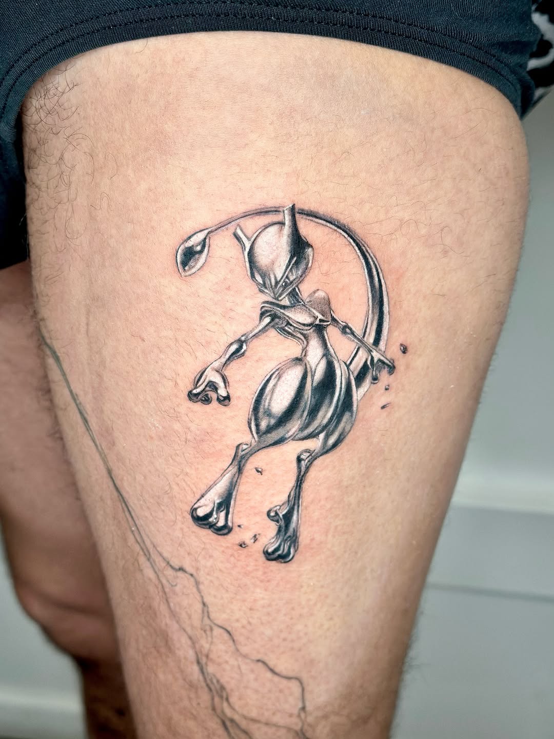 Mewtwo from Pokemon new school tattoo on the thigh by Bay Area Tattoo Artist