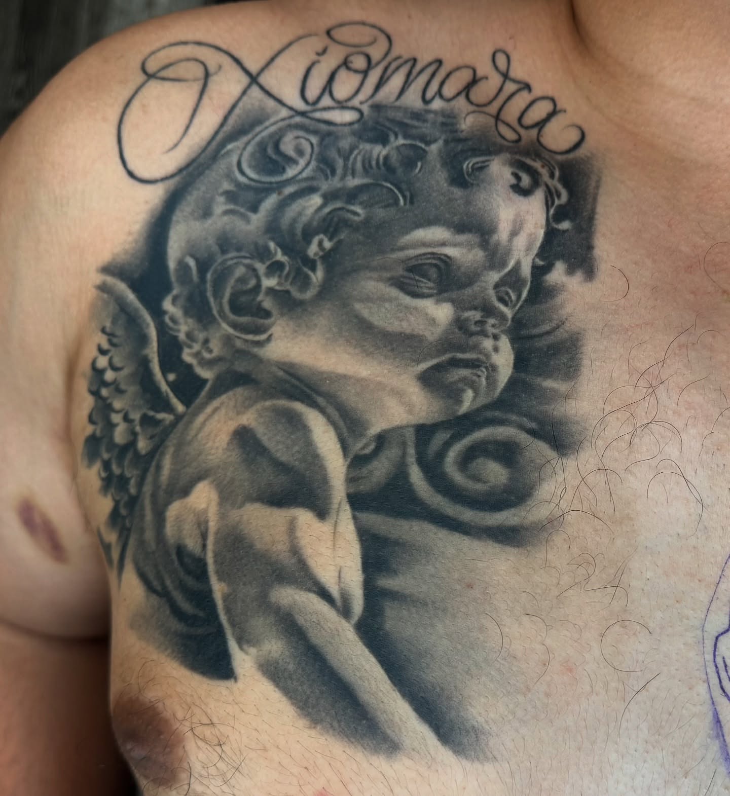 Cherub realism tattoo on the chest by Angel Pineda-Rodriguez