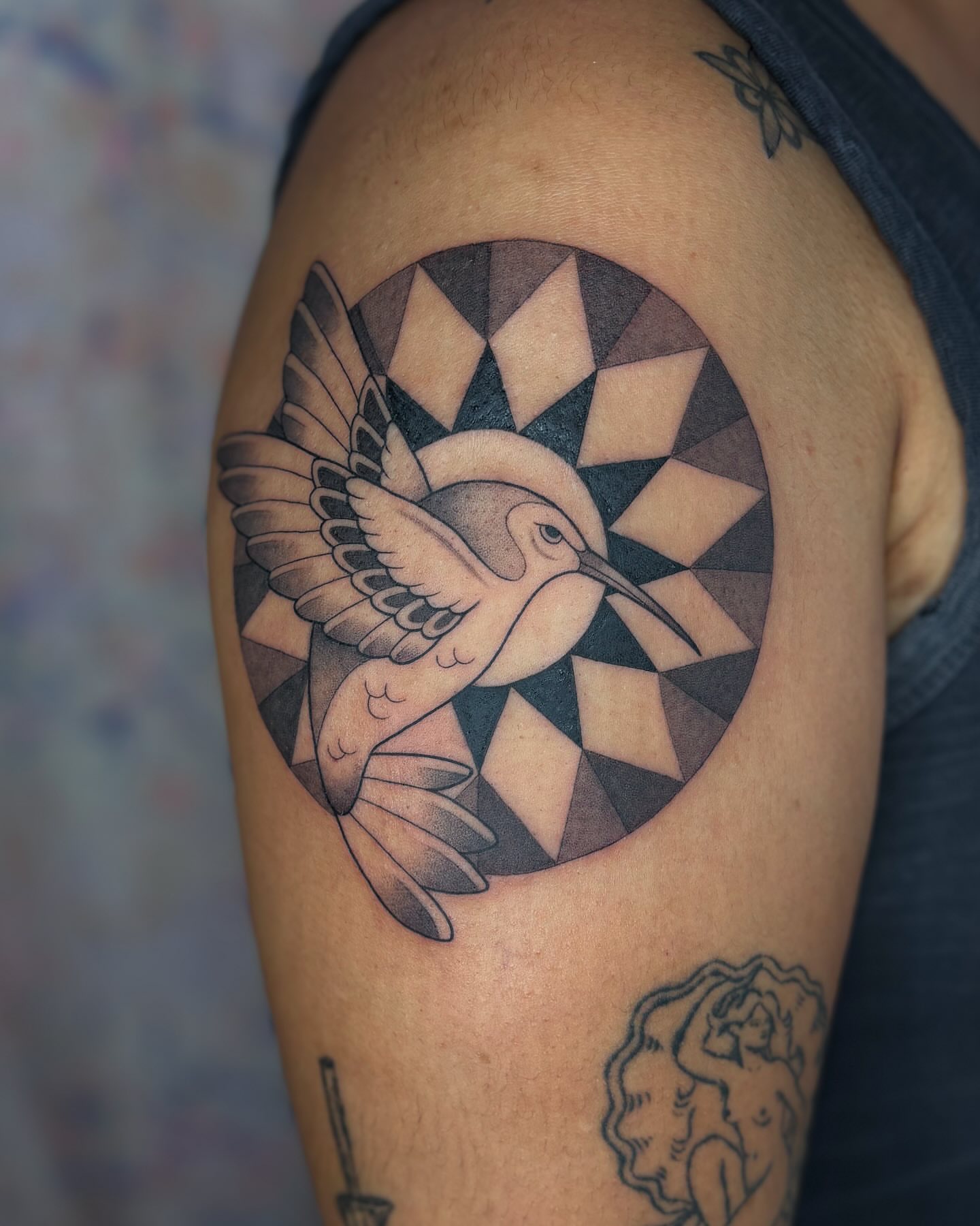 Bird geometric tattoo on the shoulder by Anna Sage