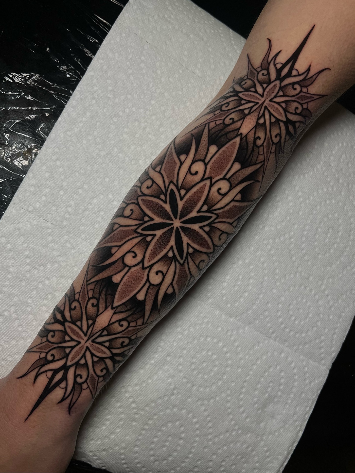 Floral mandala ornamental tattoo on the forearm by Bell Bolton