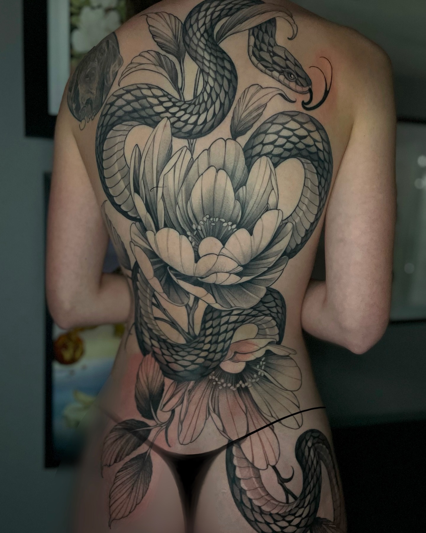 Snake and peony realism tattoo on the back by Madelyn Roberts, Bellingham, Washington