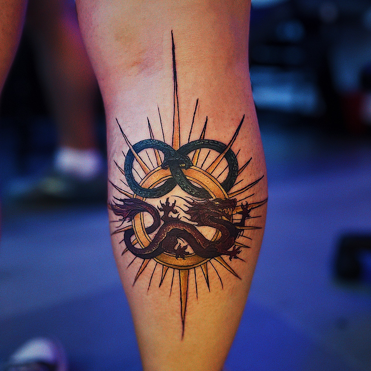 Dragon and infinity symbol neo-traditional tattoo on the forearm by Nikki Ward
