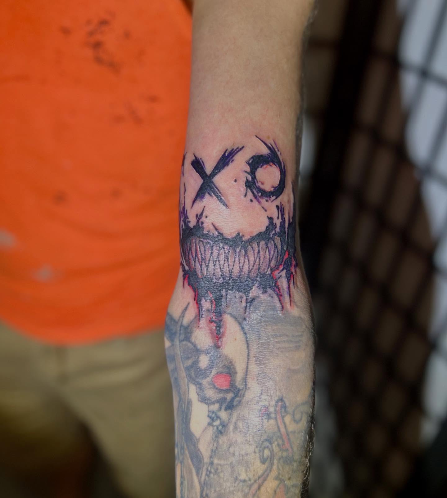 Skull with mouth black and grey tattoo on the forearm by ɢɢ sᴛʏʟᴇs