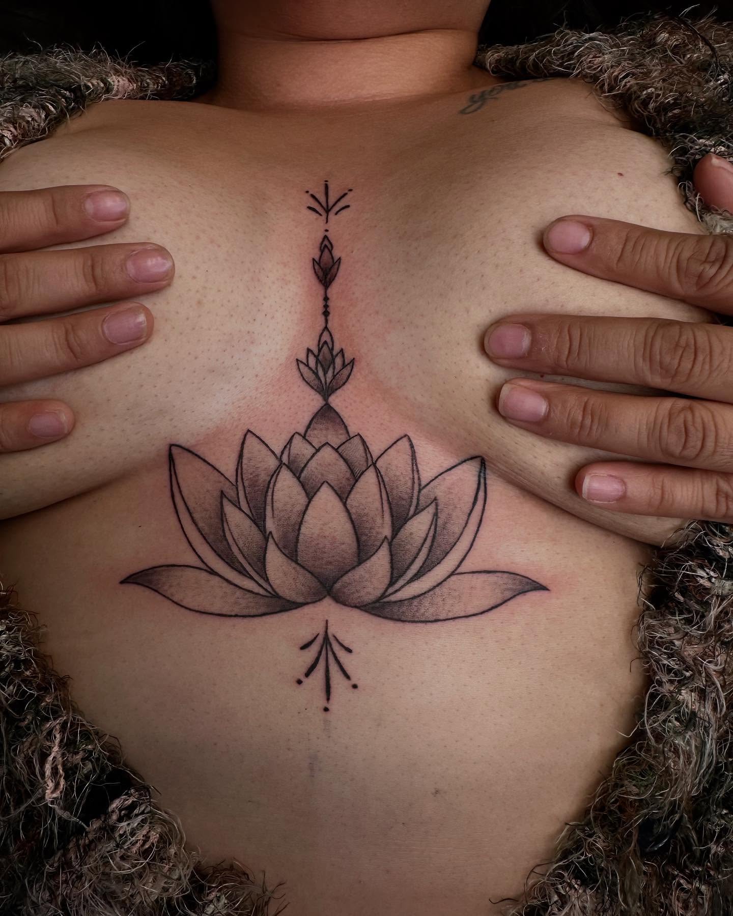 Lotus flower black and grey tattoo on the chest by Kimberly landin