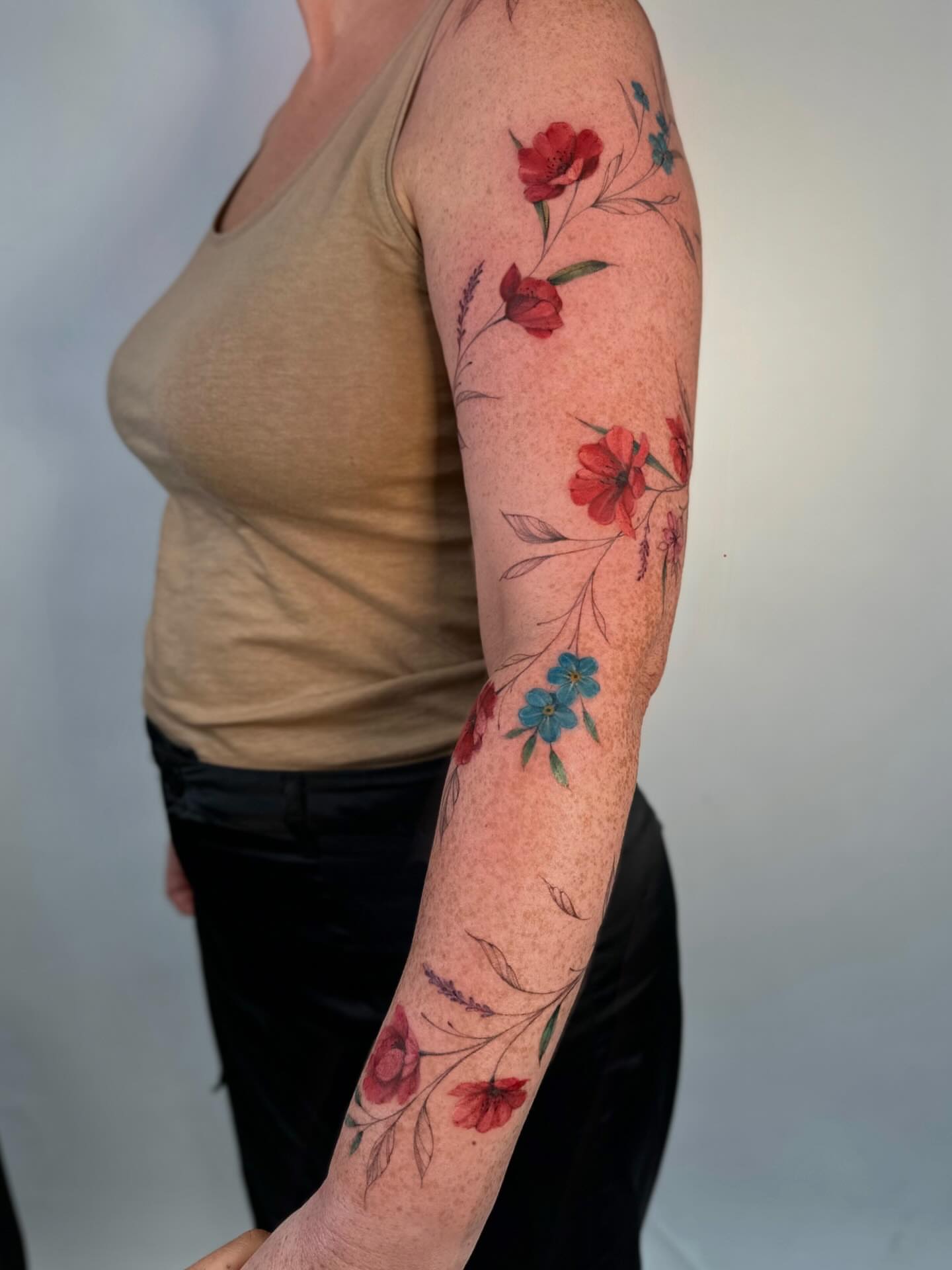Floral arrangement watercolor tattoo on the forearm by Thin line and color TATTOO.