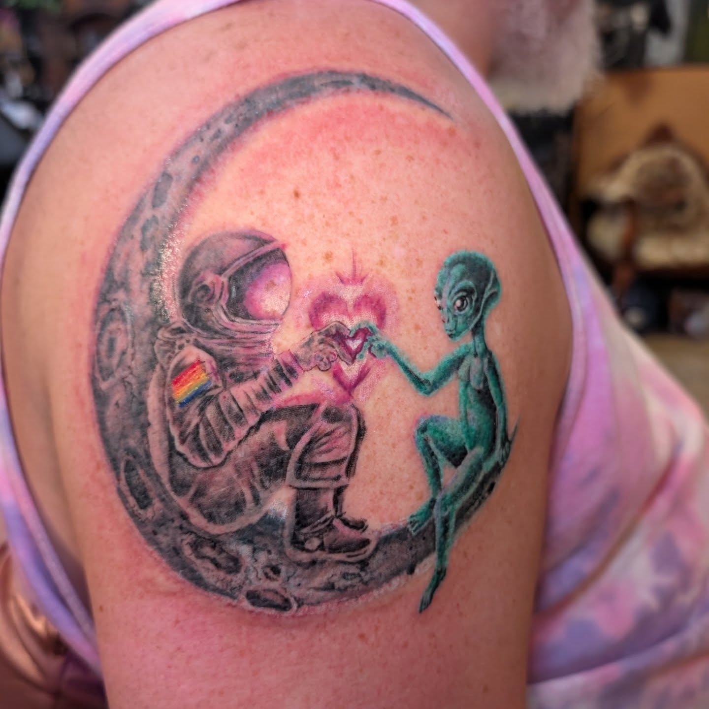 Astronaut and alien realism tattoo on the shoulder by Cat