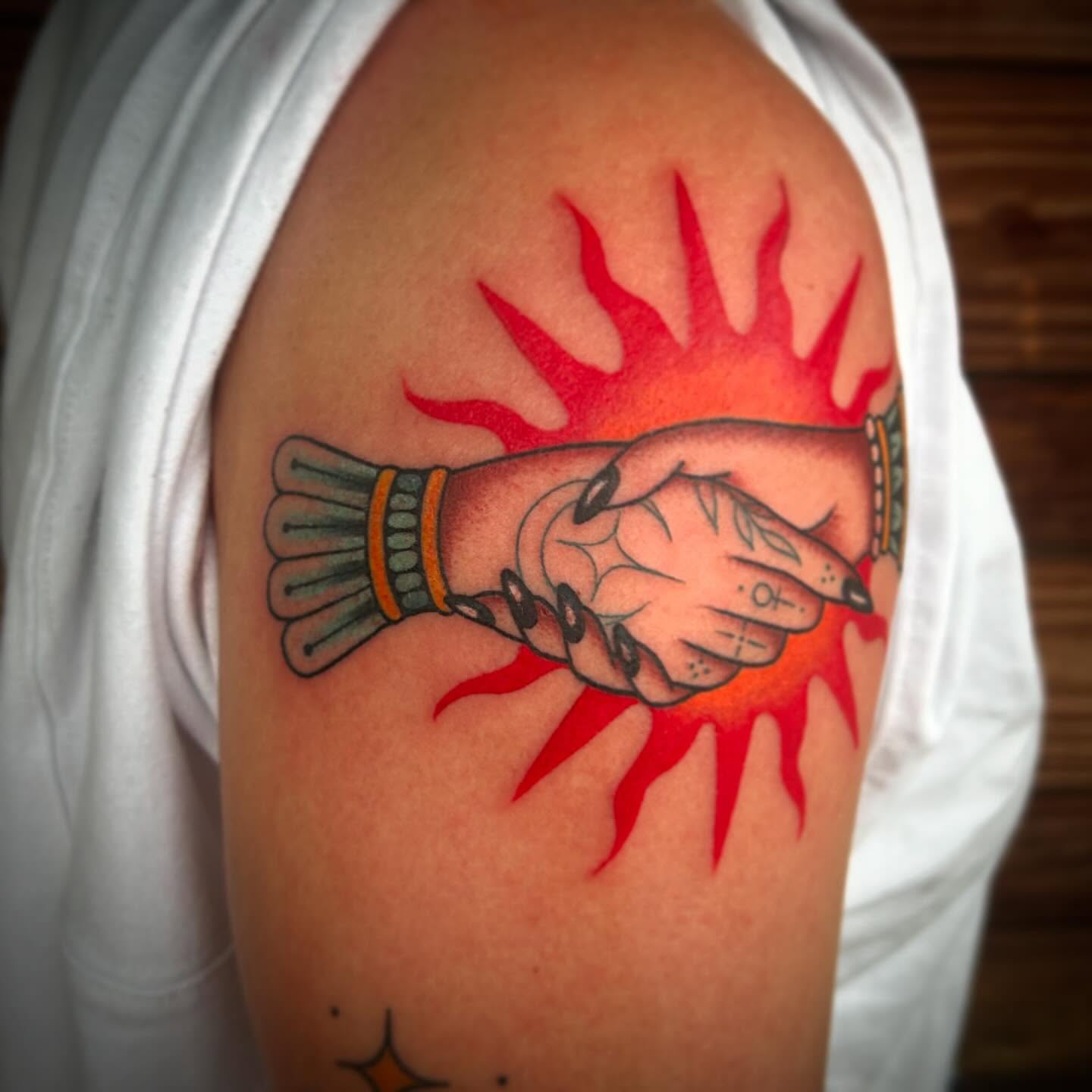 Handshake American traditional tattoo on the shoulder by Kayla Shoffner