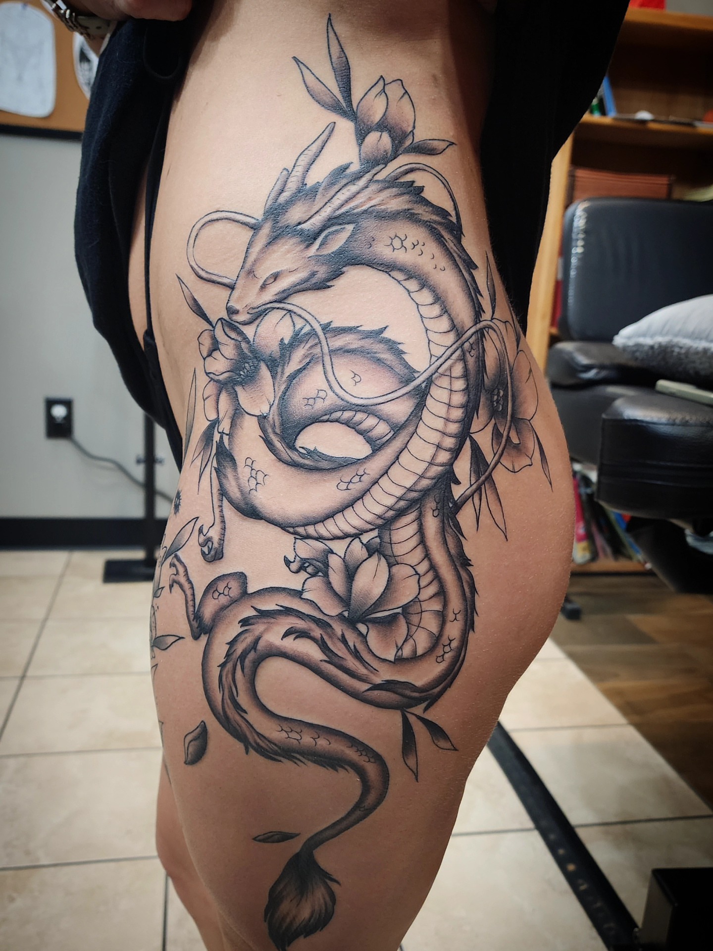 Dragon black and grey tattoo on the thigh by bobby allensworth