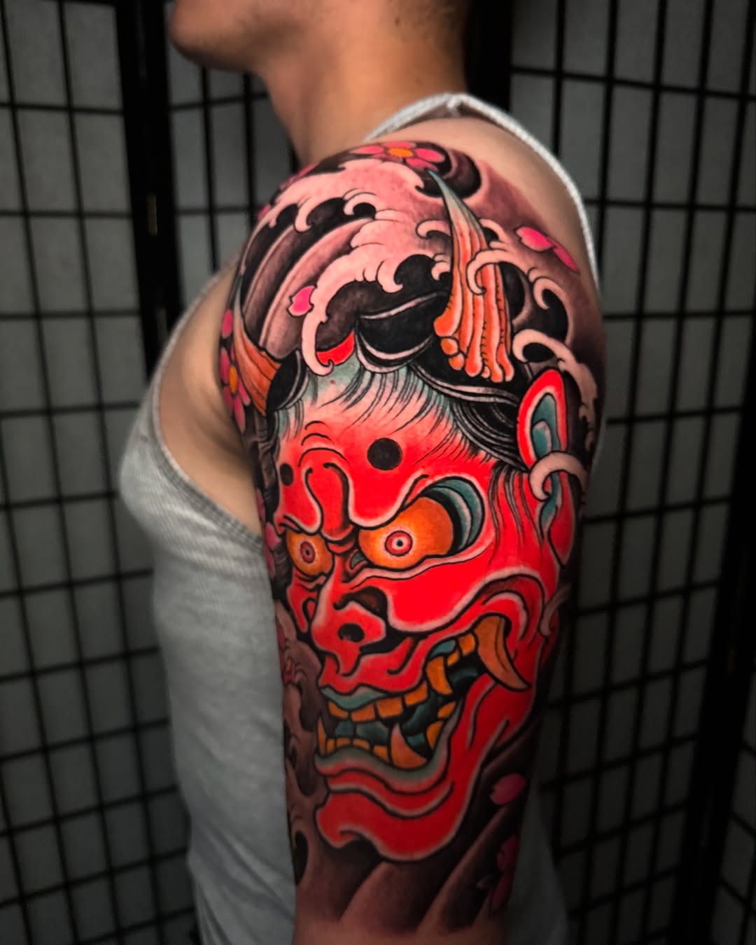 Oni mask and waves Japanese tattoo on the upper arm by 𝙉𝙄𝘾𝙆 𝘾𝘼𝙍𝙐𝙎𝙊, New York, New York