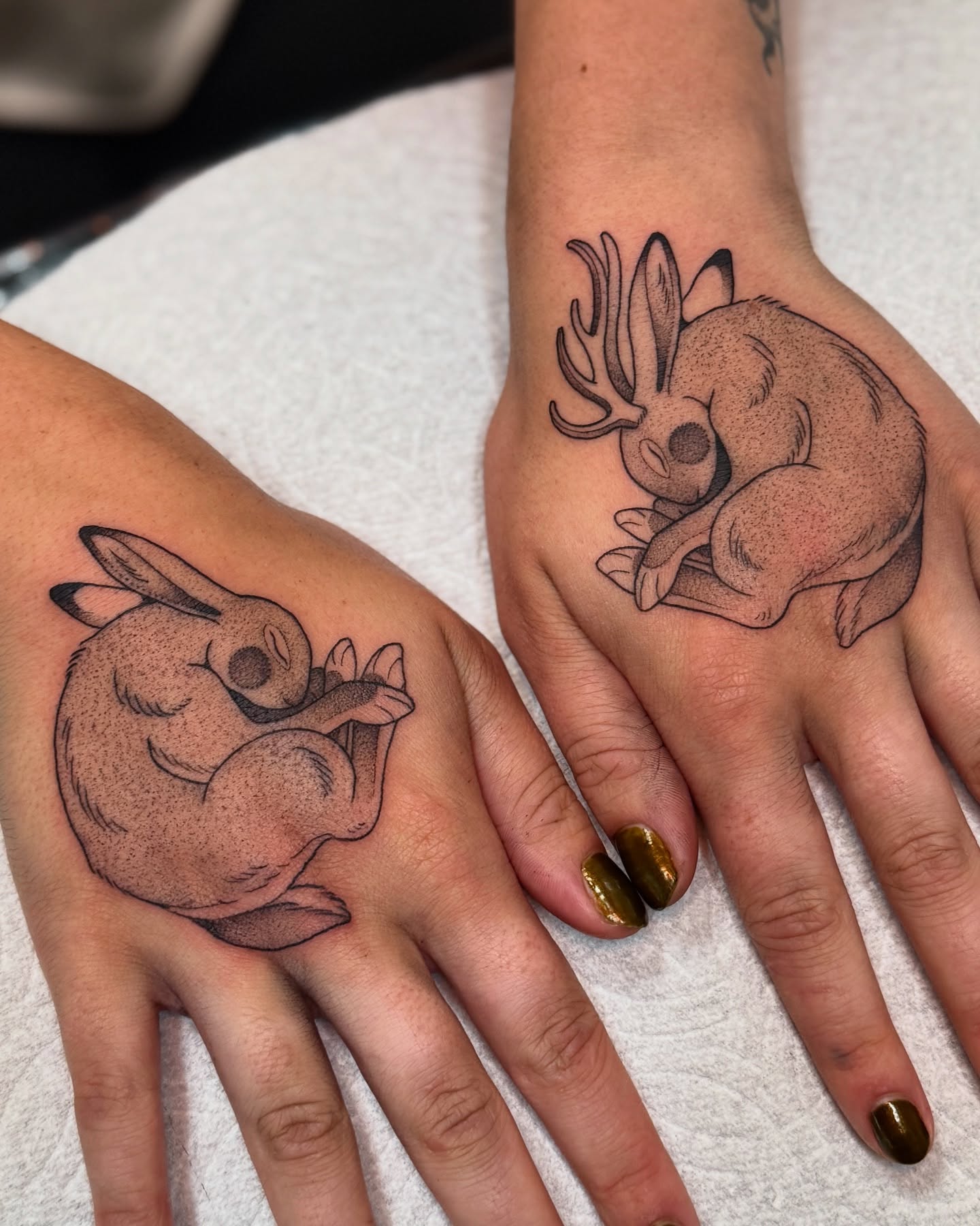 Sleeping creatures black and grey tattoo on the hand by Connor🍄🏳️‍⚧️