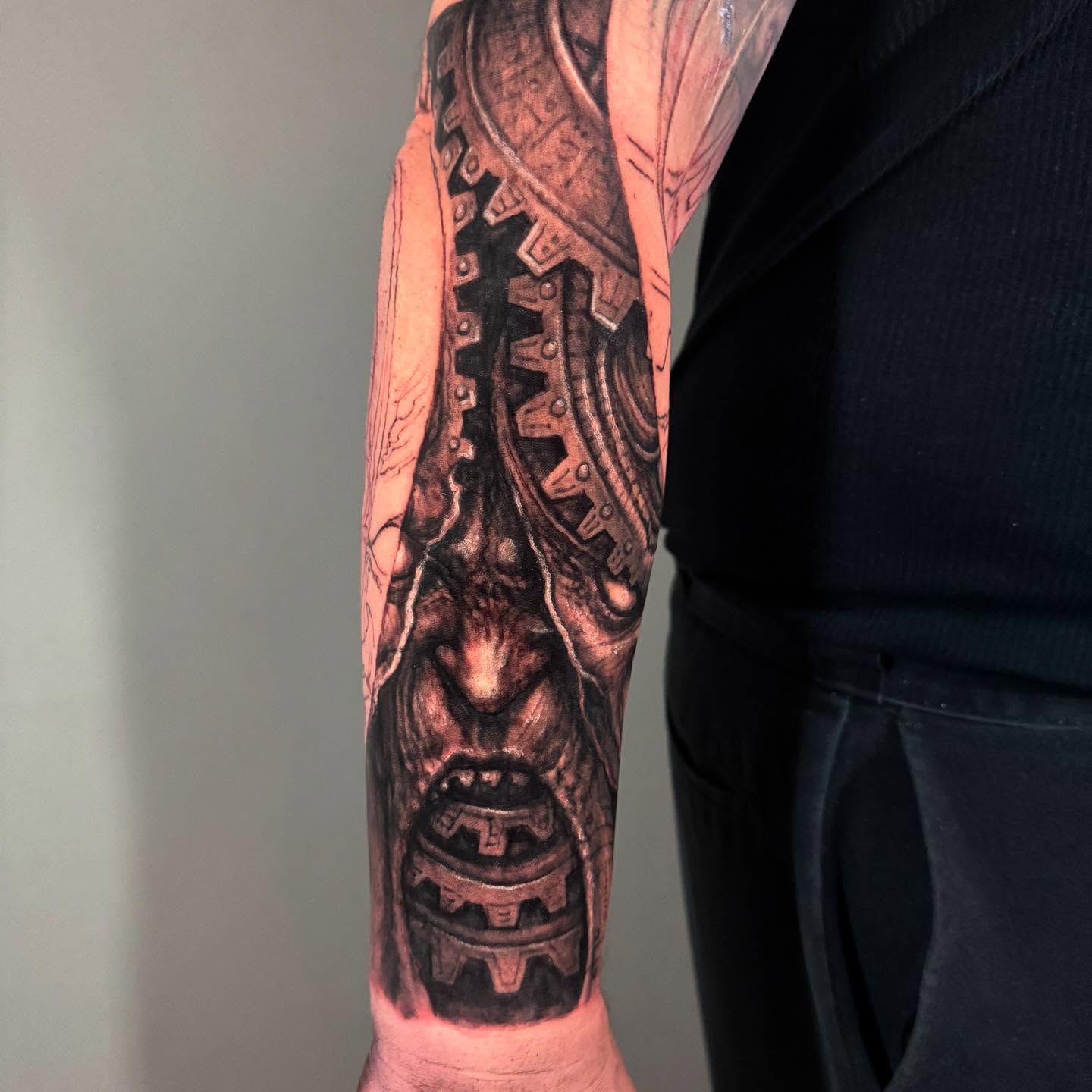 Mechanical gears realism tattoo on the forearm by Paul Booth
