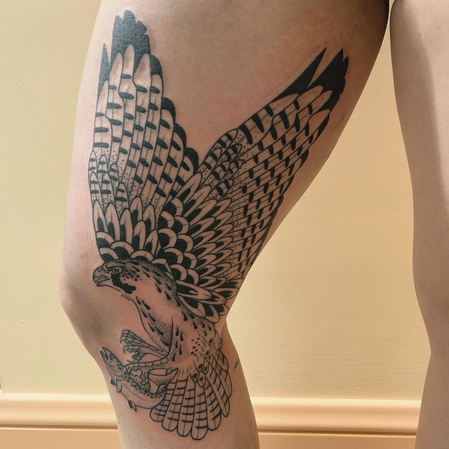 Hawk black and grey tattoo on the thigh by Erica Finley
