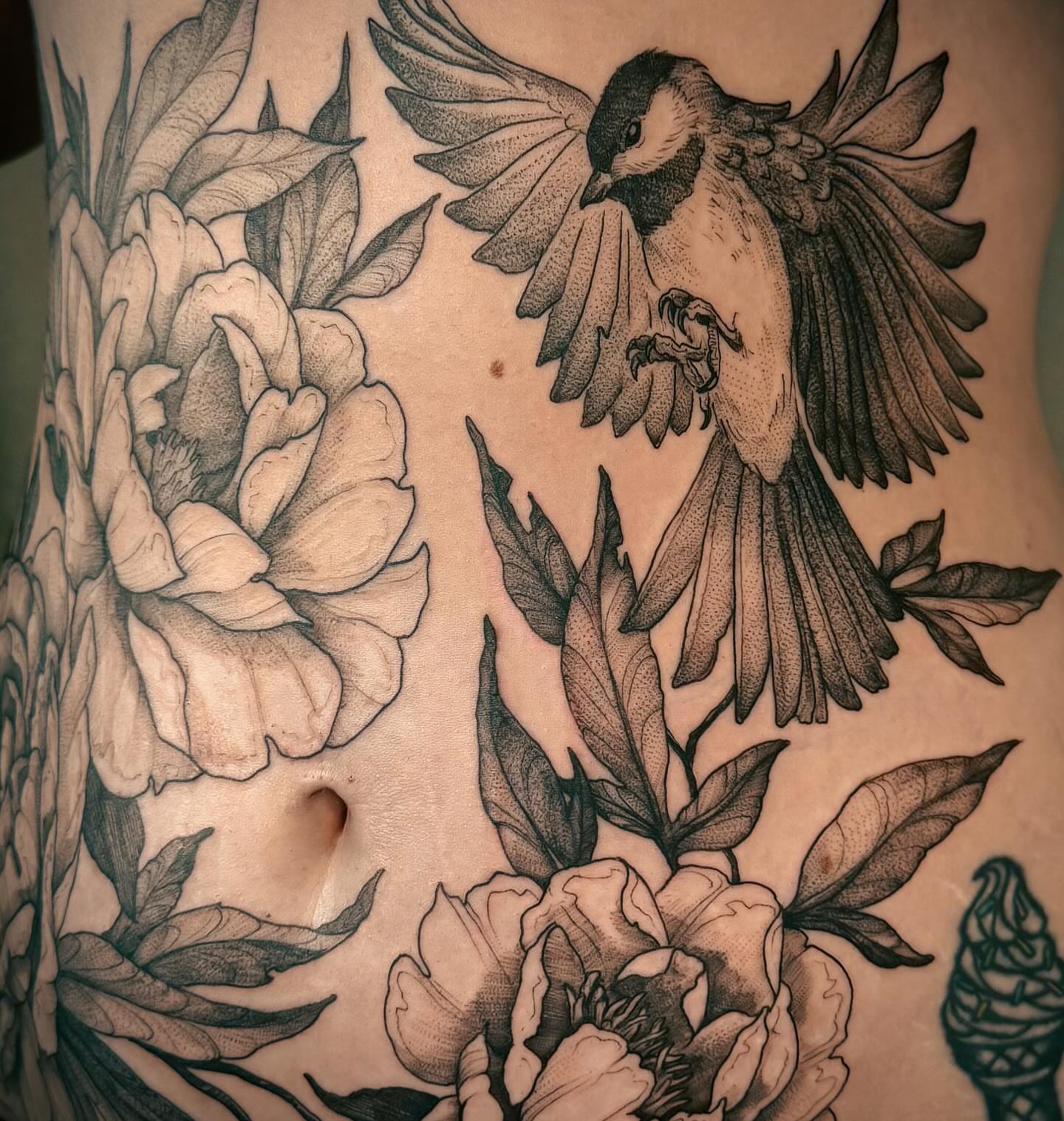 Bird and flowers realism tattoo on the torso by Renee (Koi) Vance