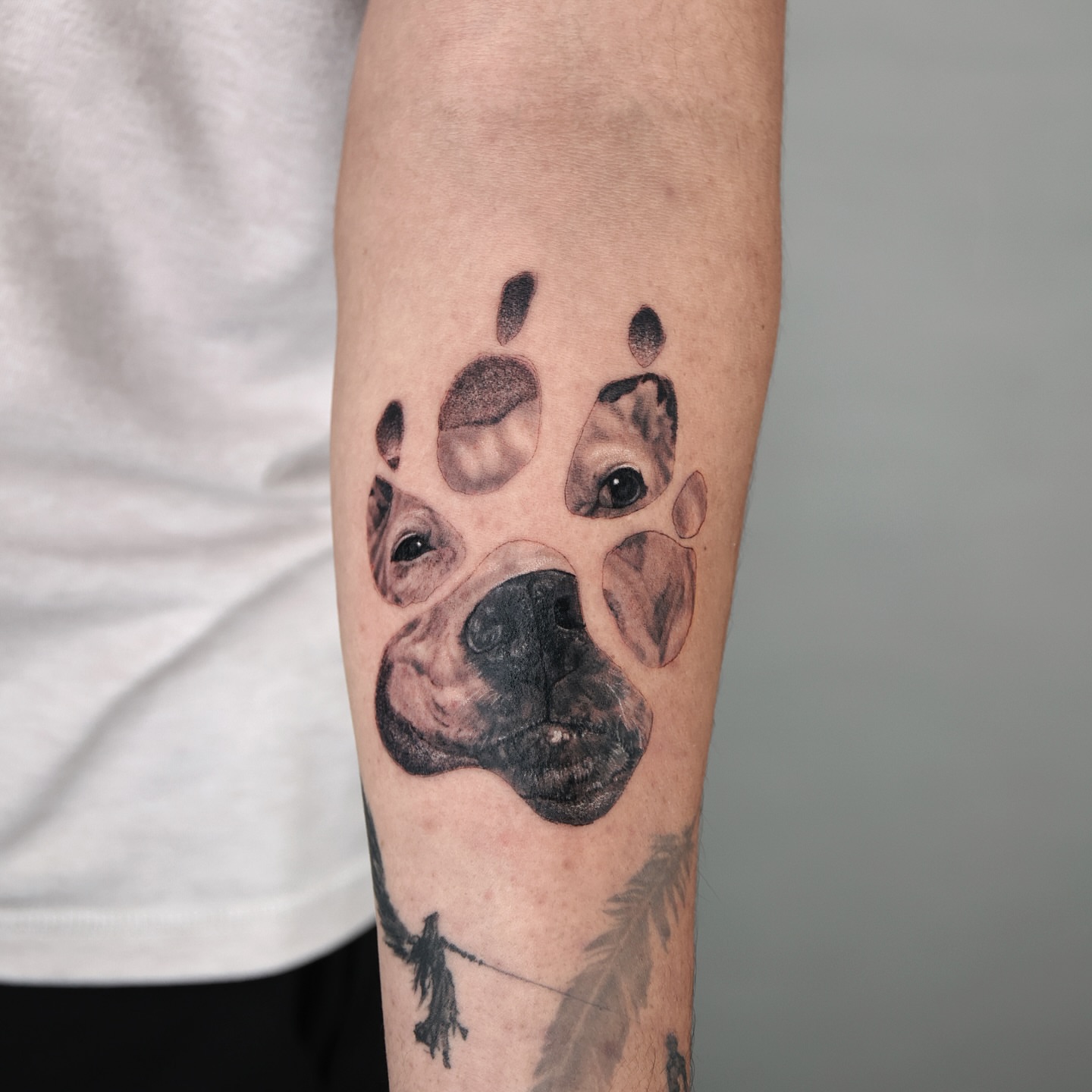 Dog paw realism tattoo on the forearm by Adam_Zhiwei Xu(Tattooist)