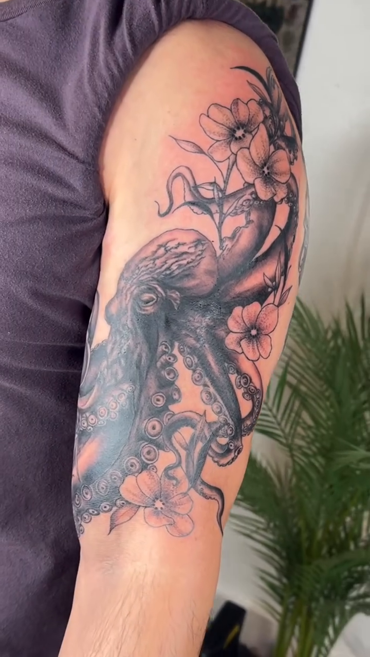 Octopus and flowers realism tattoo by Sydney