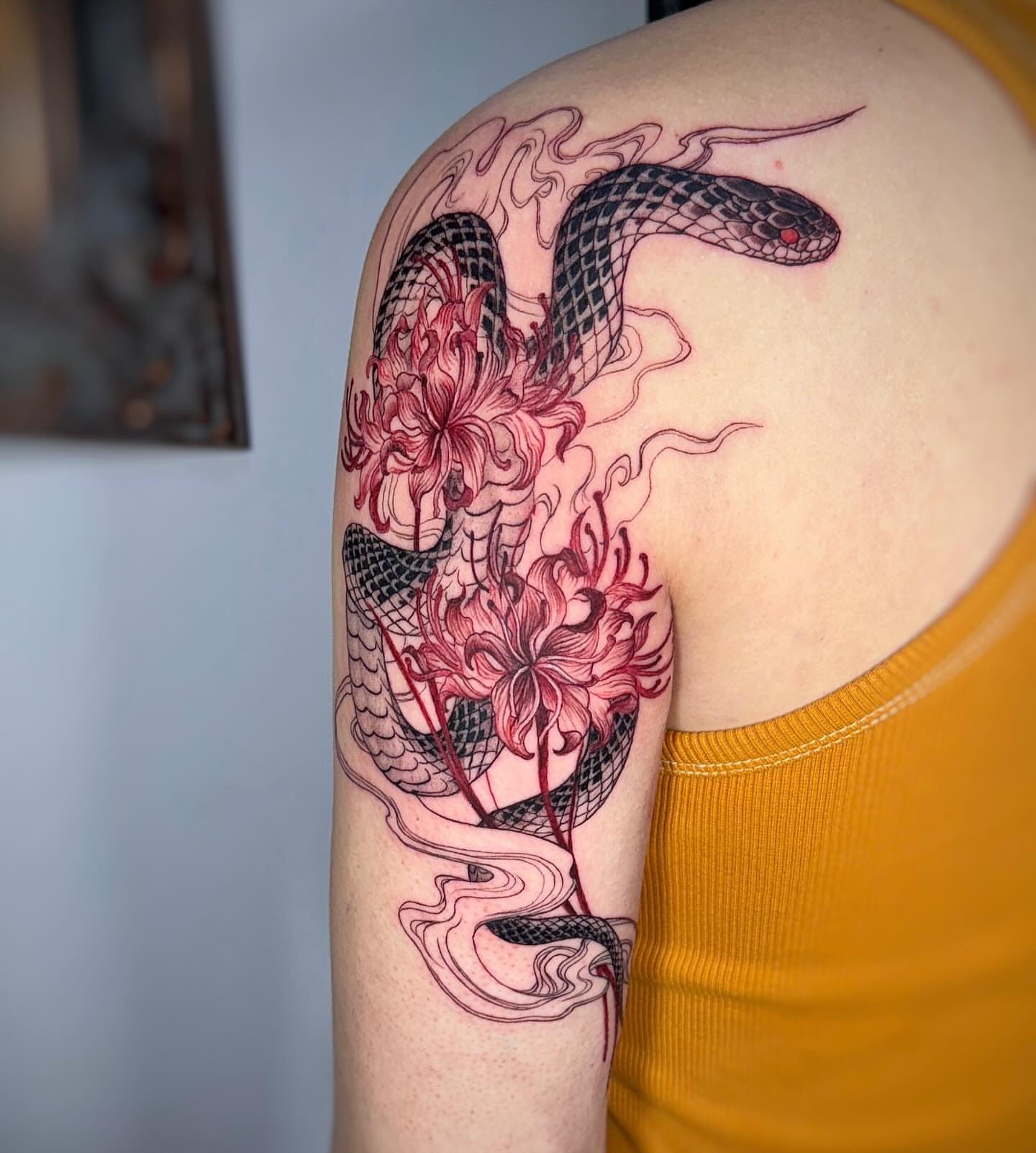 Snake and flowers realism tattoo on the shoulder by Jemin Ren