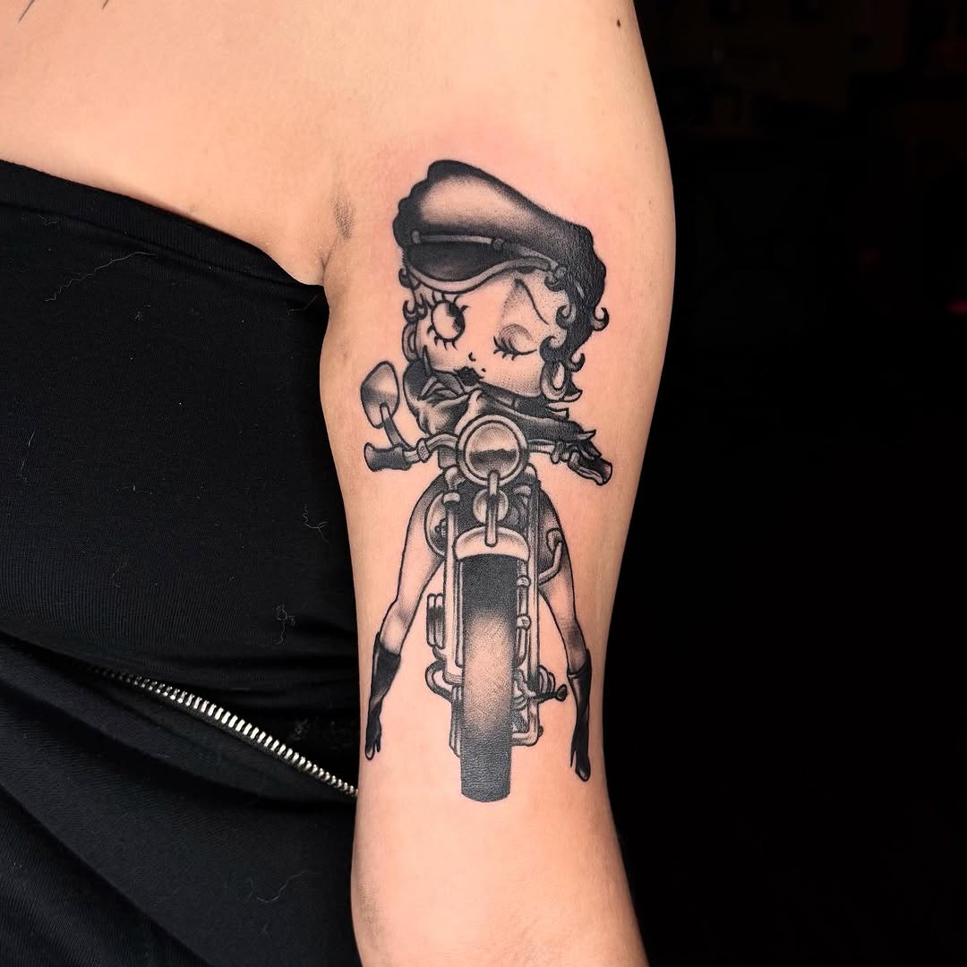 Betty Boop on a motorcycle realism tattoo on the forearm by ๐ฅ๐๐ท๐ข๐ฉ