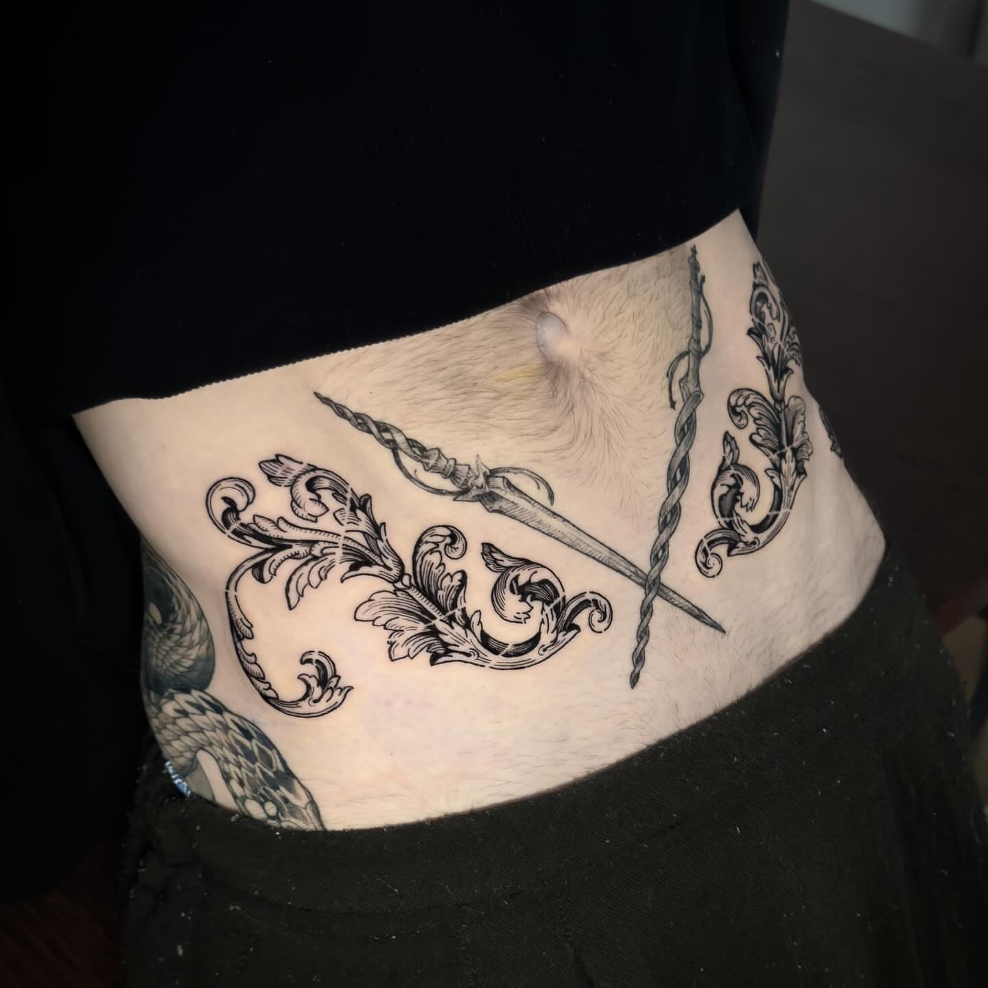 Sword and floral ornament ornamental tattoo on the torso by Dokk
