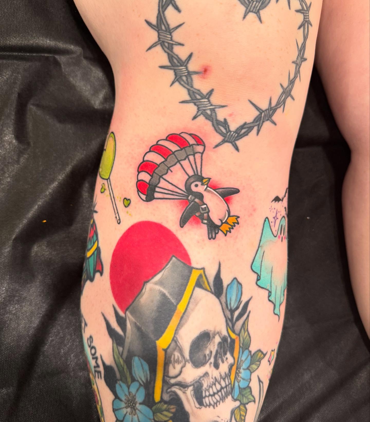 Parachuting penguin American traditional tattoo on the forearm by Jay Espinoza-AZ Tattooer