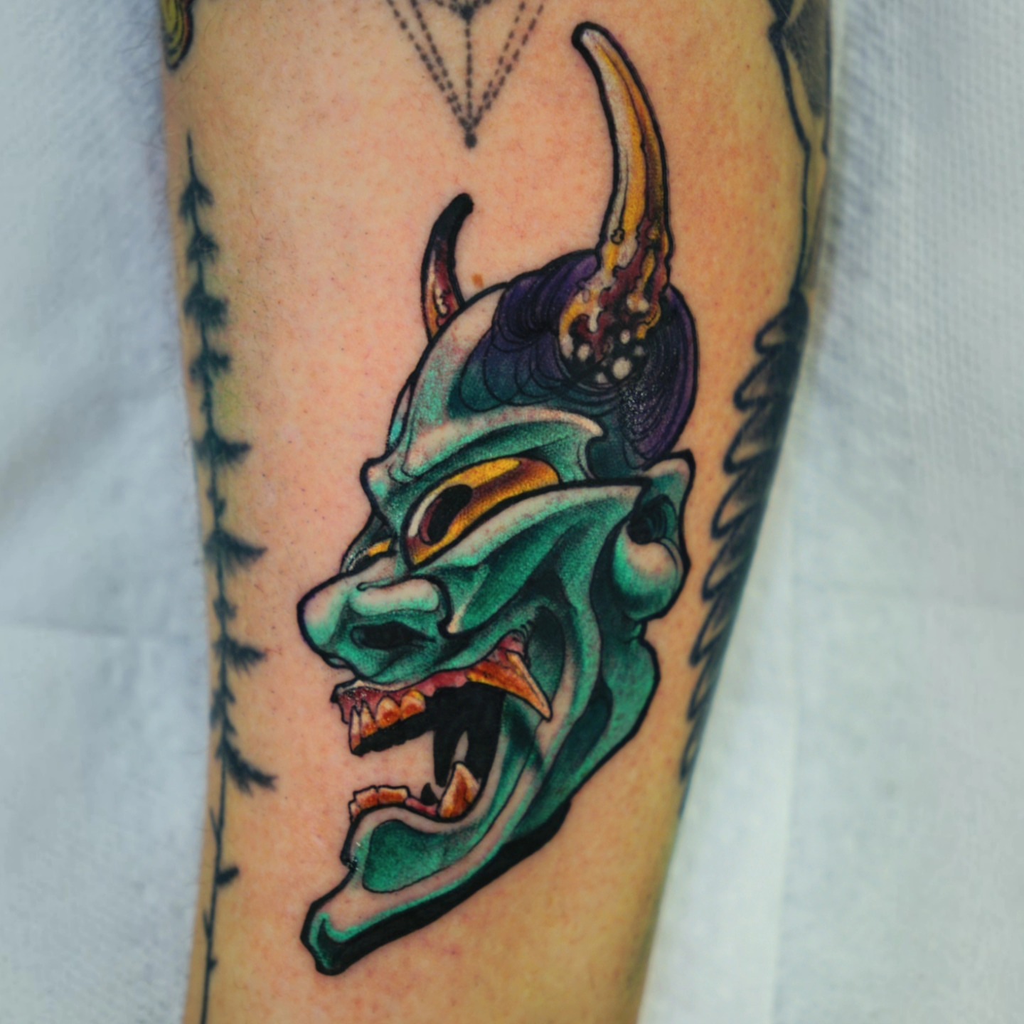 Demon mask American traditional tattoo on the forearm by Justin Byrd, Kansas City, Missouri