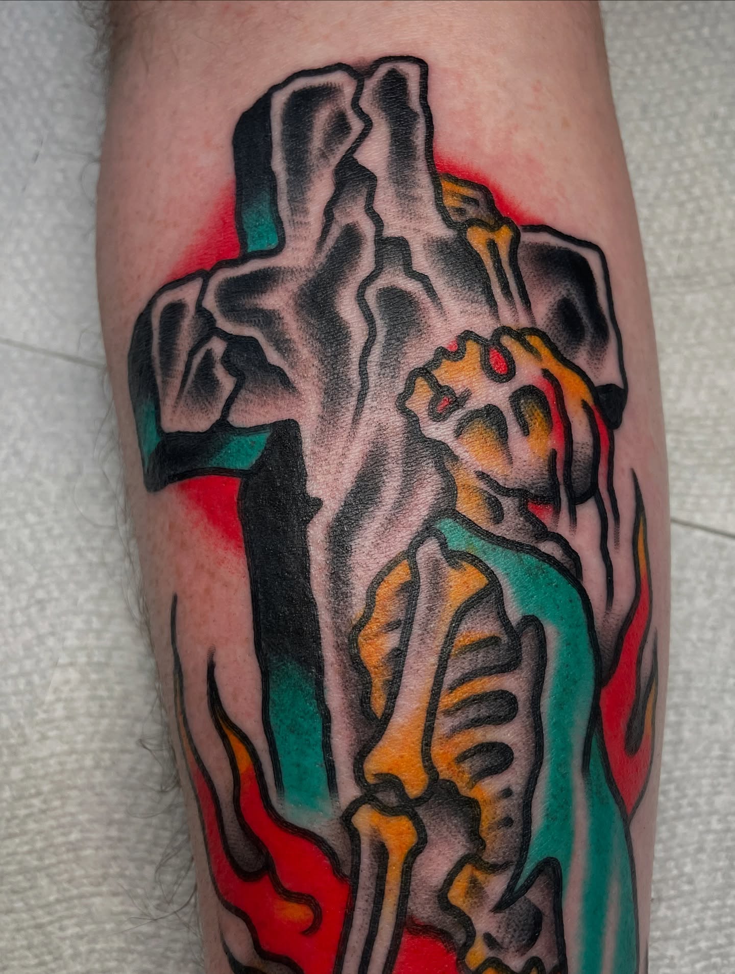 Cross and figure American traditional tattoo on the forearm by David Armacost, Cincinnati, Ohio