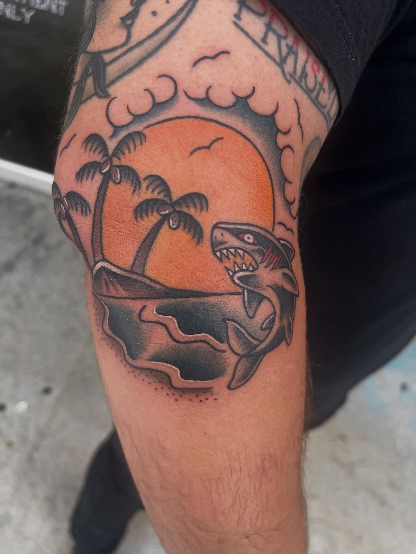 Shark attack scene American traditional tattoo on the forearm by Ashley matthews