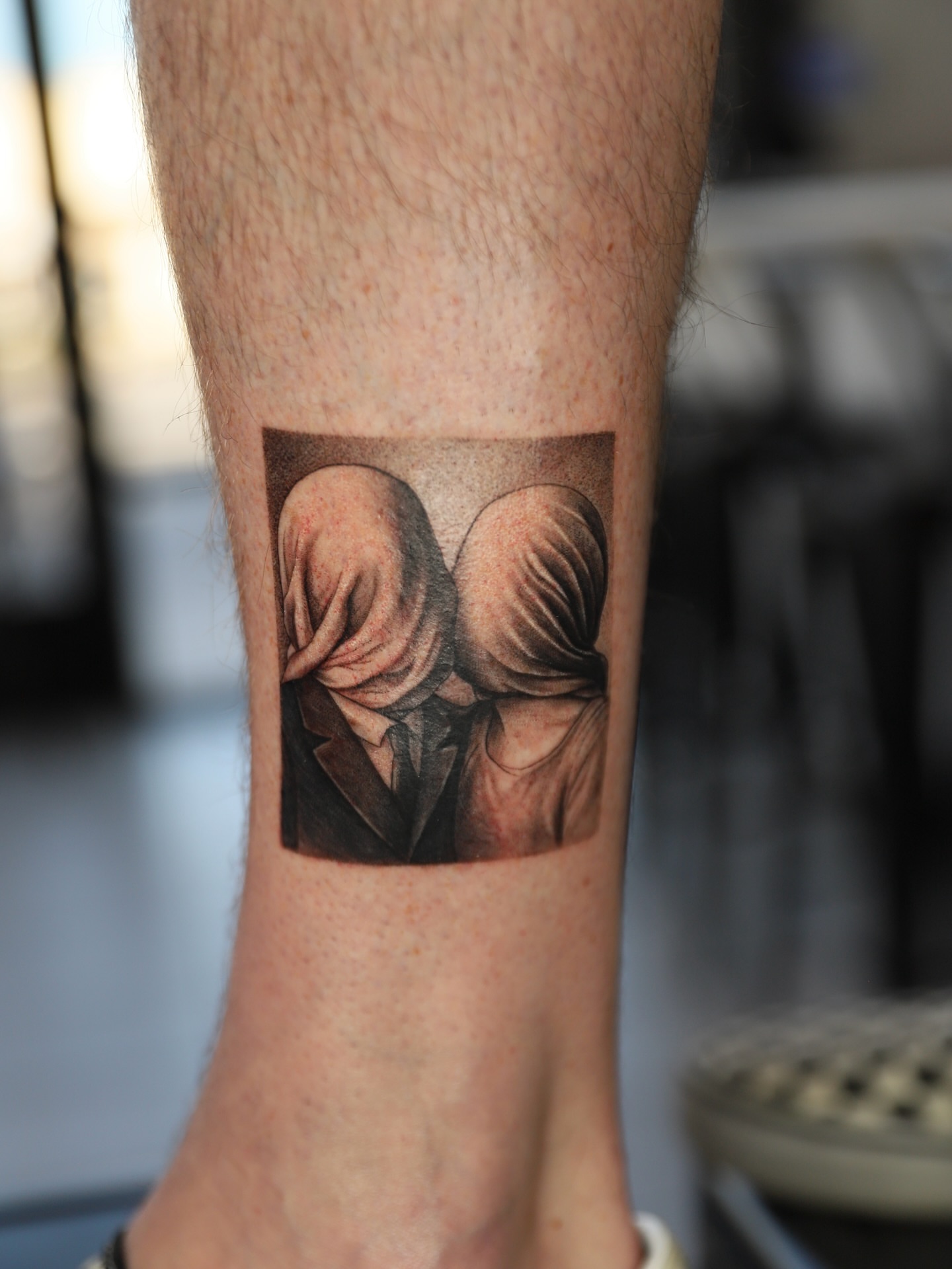 Couple kissing realism tattoo on the forearm by Las Vegas tattoo