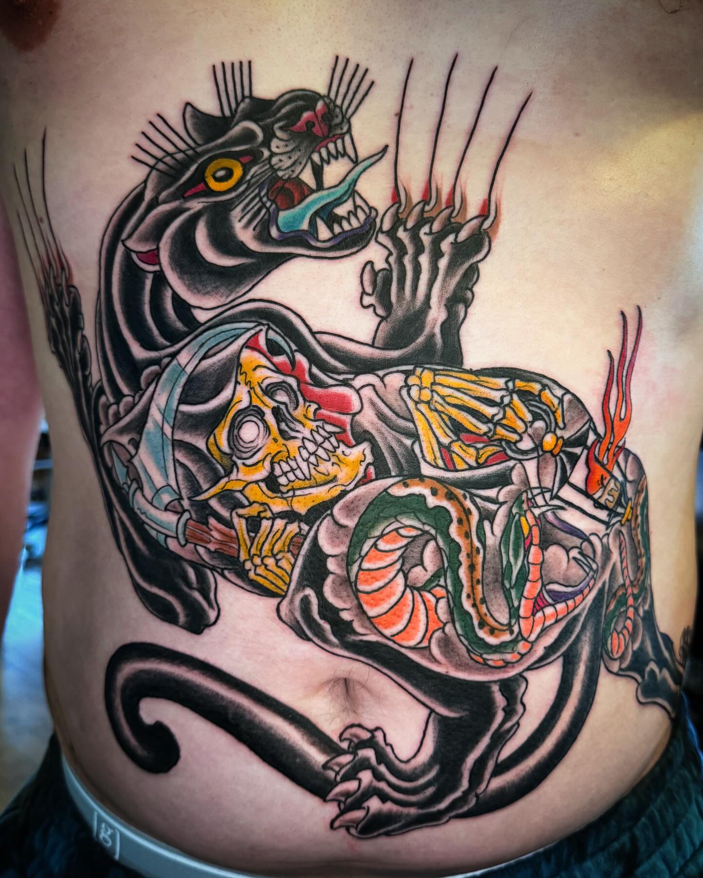 Skull and dragon American traditional tattoo on the ribs by Bob Lackner