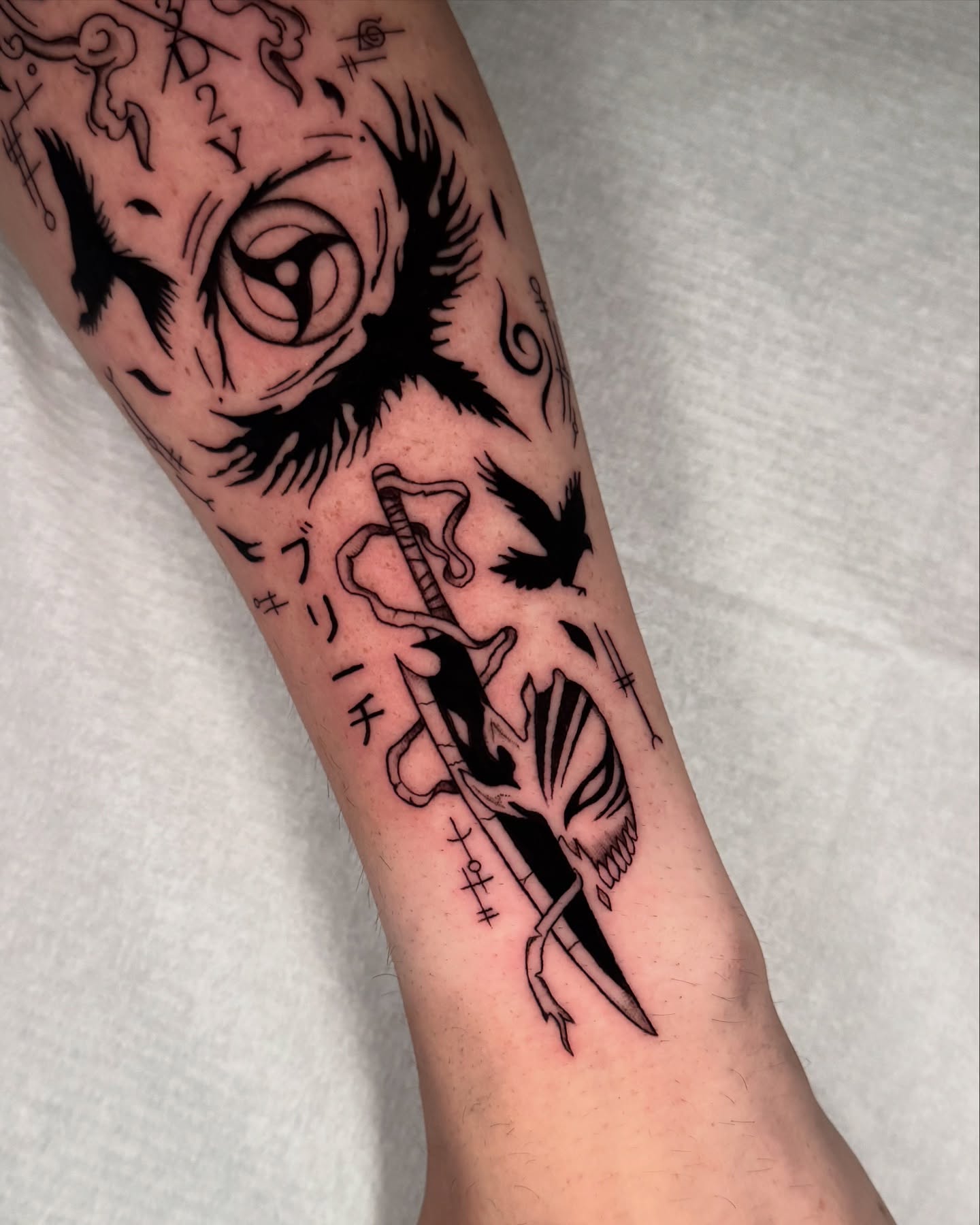 Owl and bird black and grey tattoo on the forearm by kelsey hackett