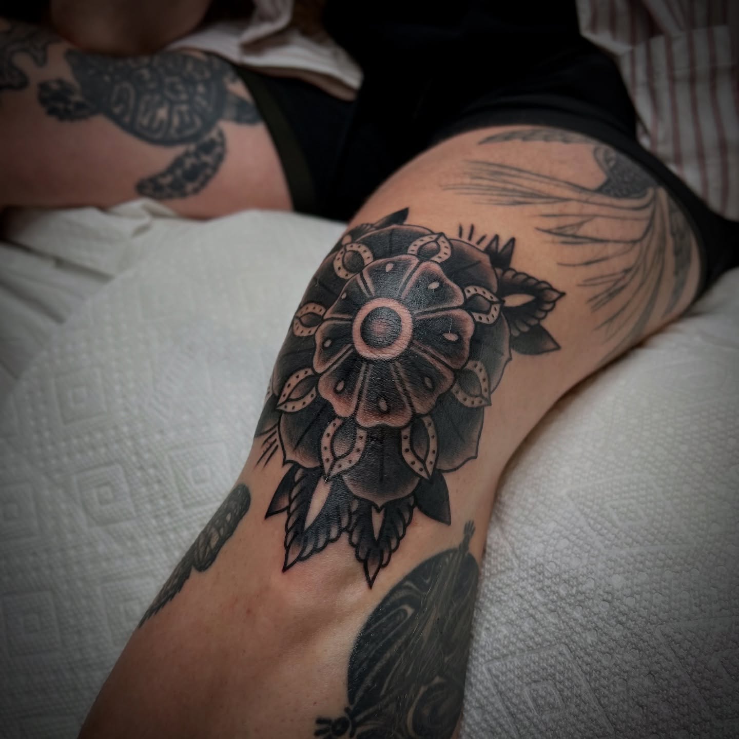 Flower black and grey tattoo on the thigh by Bright-bold-classic Tattoos, North Hills